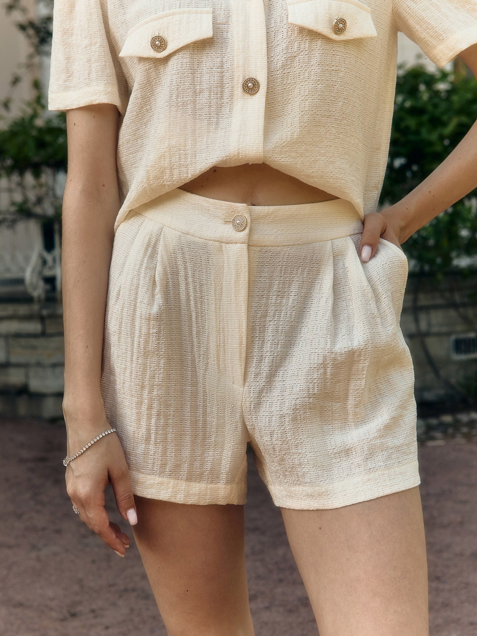 Mini shorts in textured fabric with waist pleats