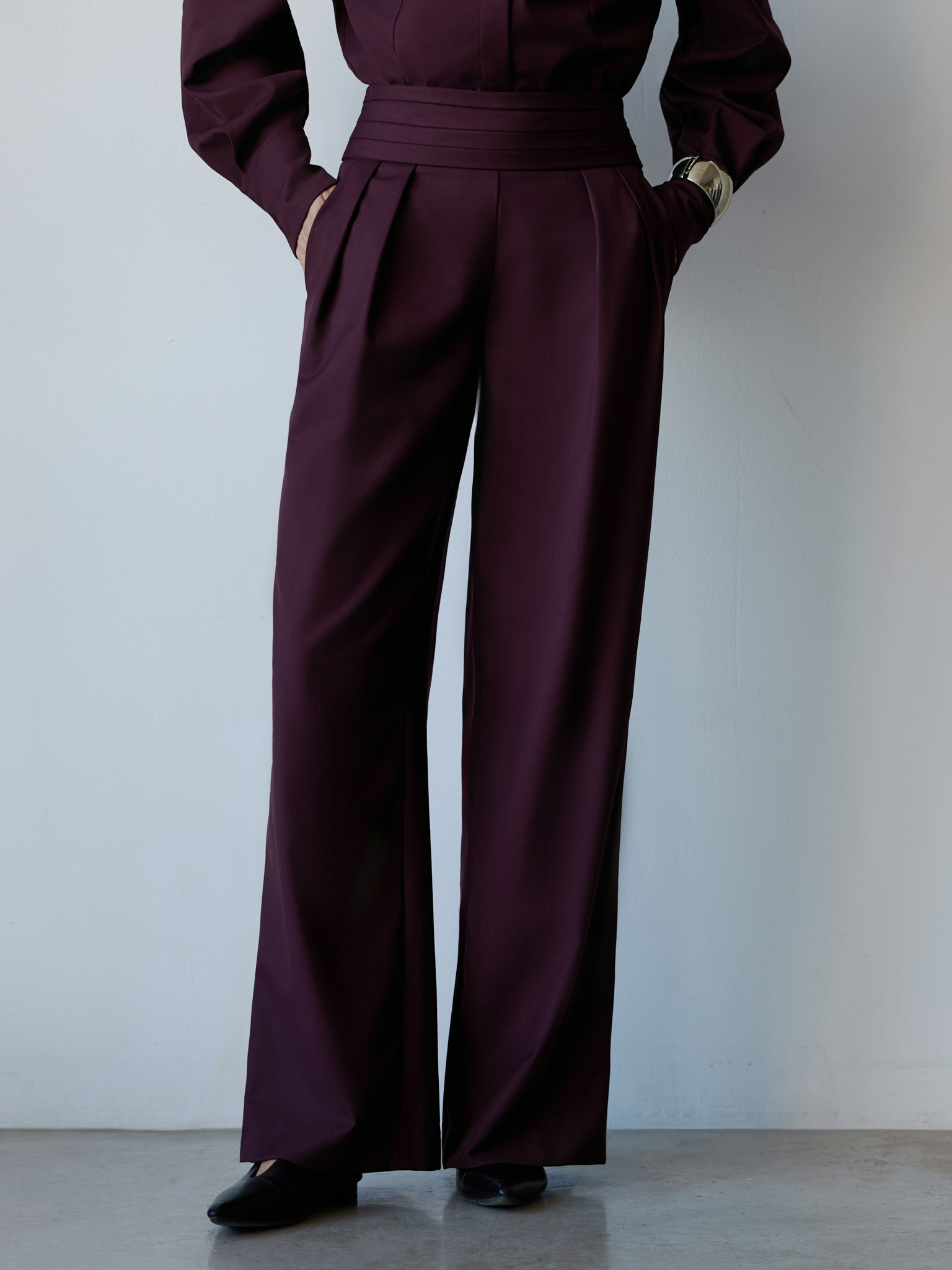 Loose trousers with wide draped belt
