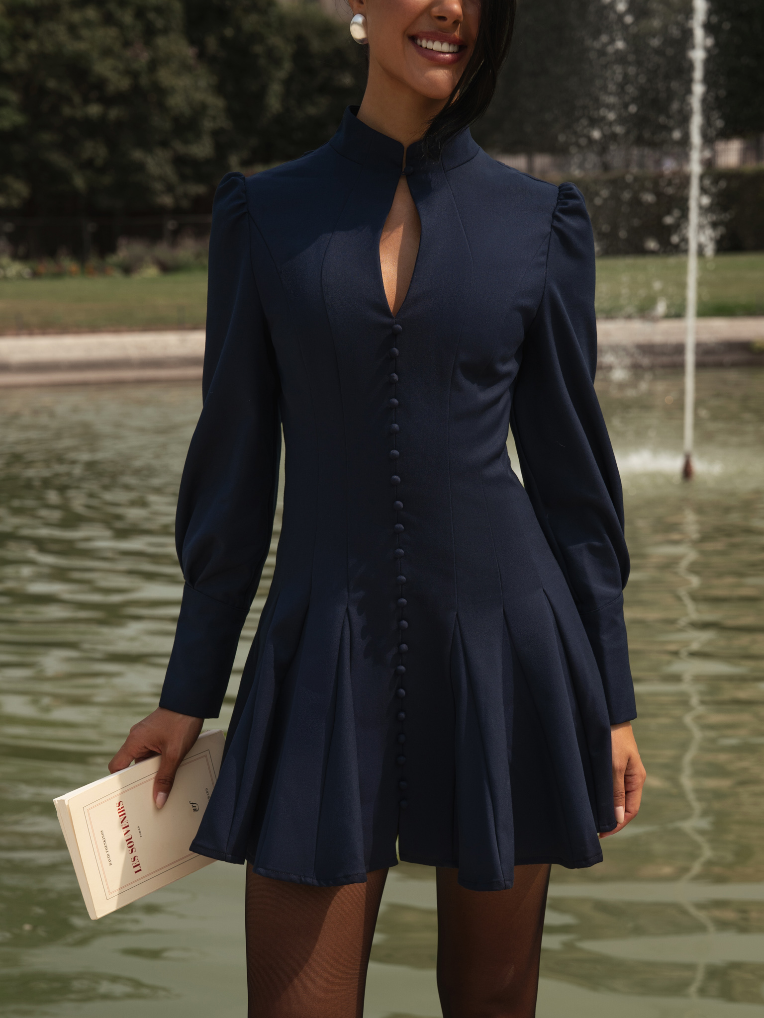 Fitted mini dress with shaped neckline and small buttons