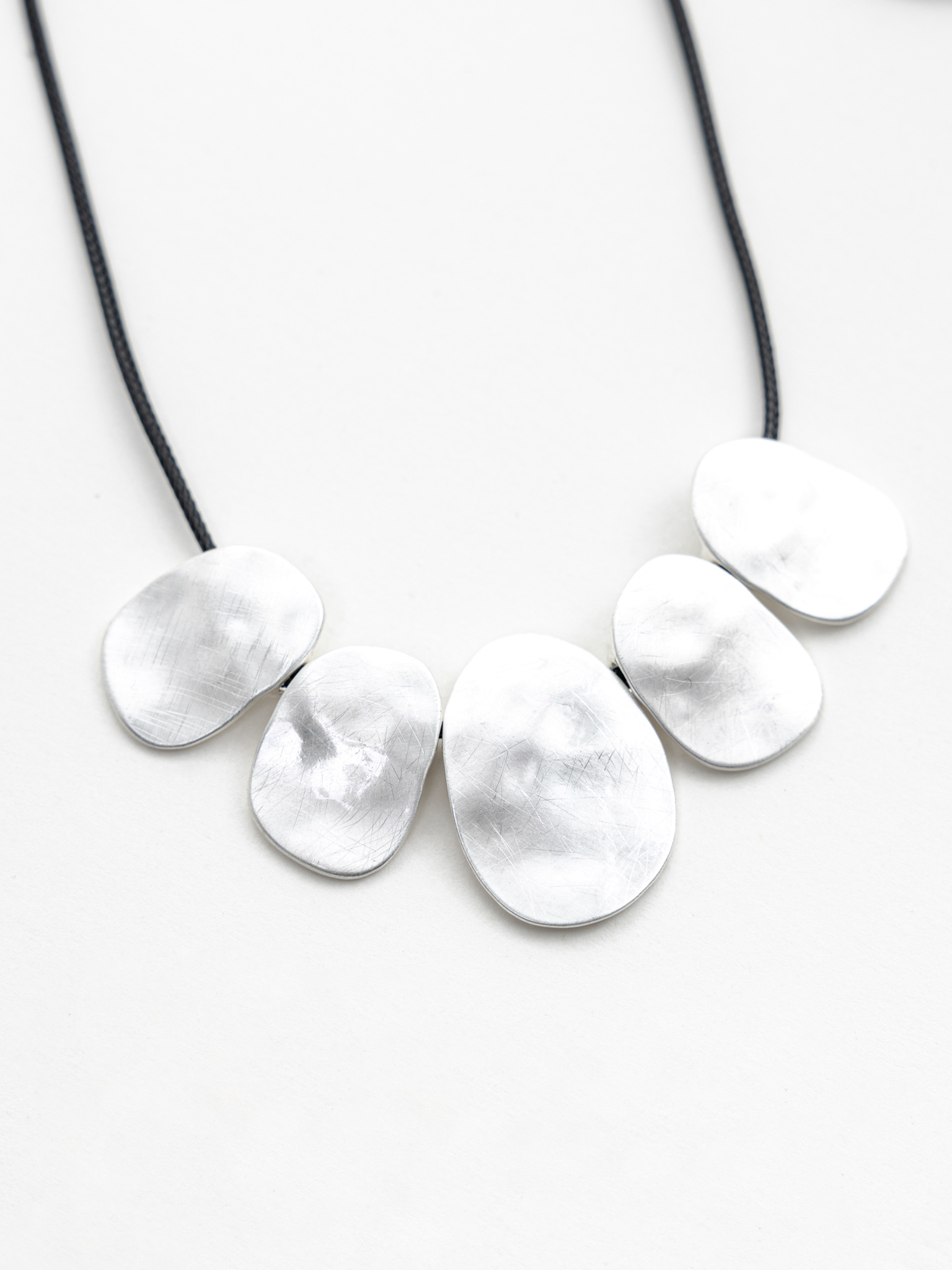 Eco-leather cord necklace with silvertone pendants