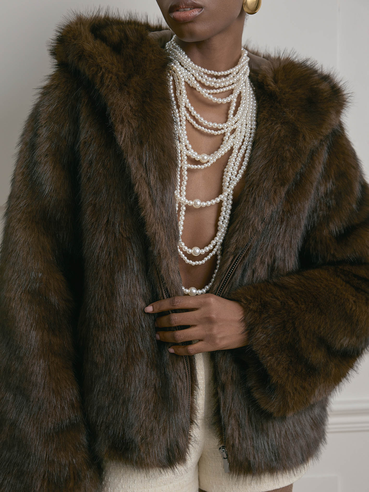 Kurzer Mantel aus Eco-Pelz mit Reißverschluss und Kapuze