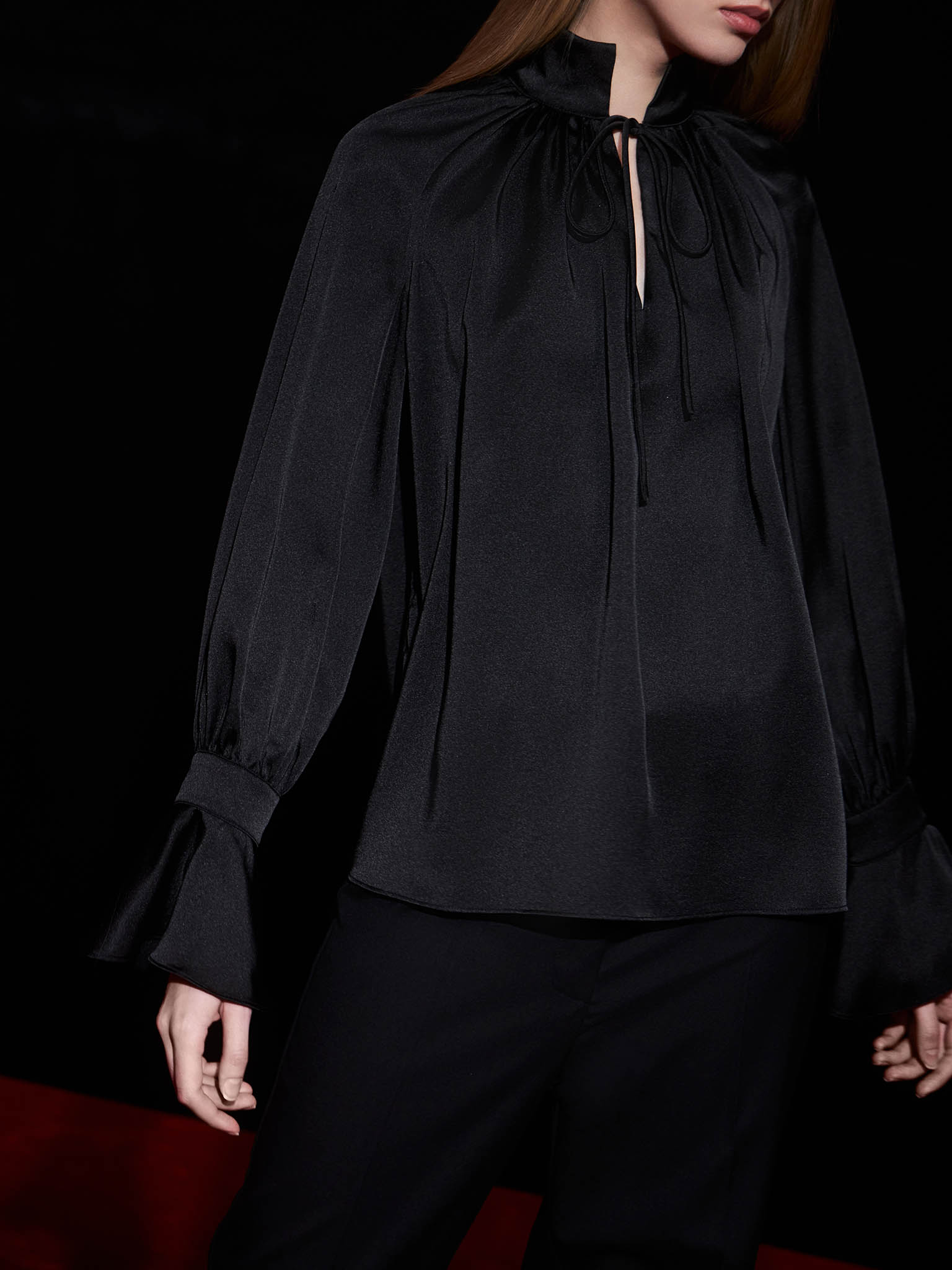 Voluminous satin blouse with ties at the collar