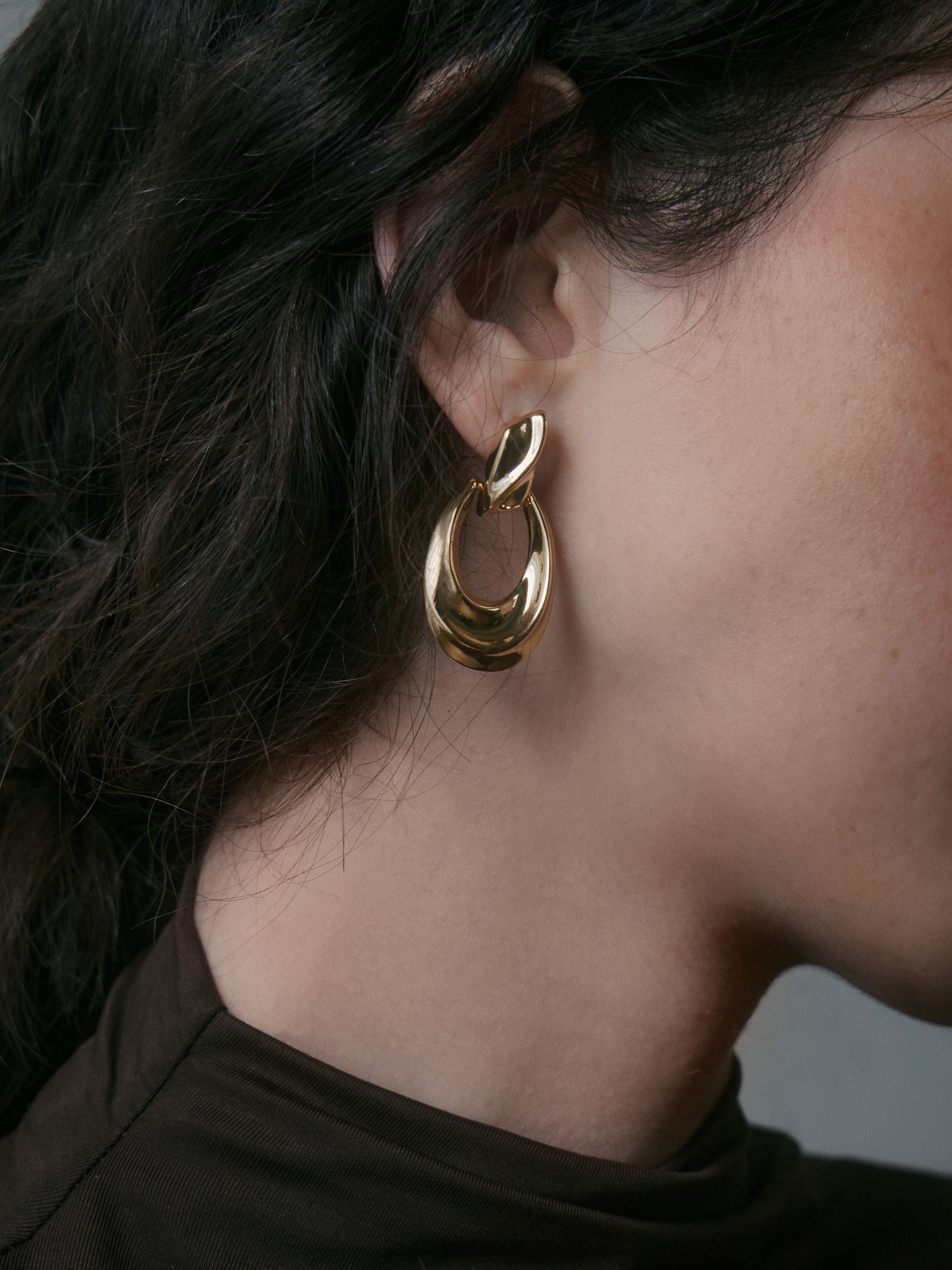 Golden stud earrings with hanging links