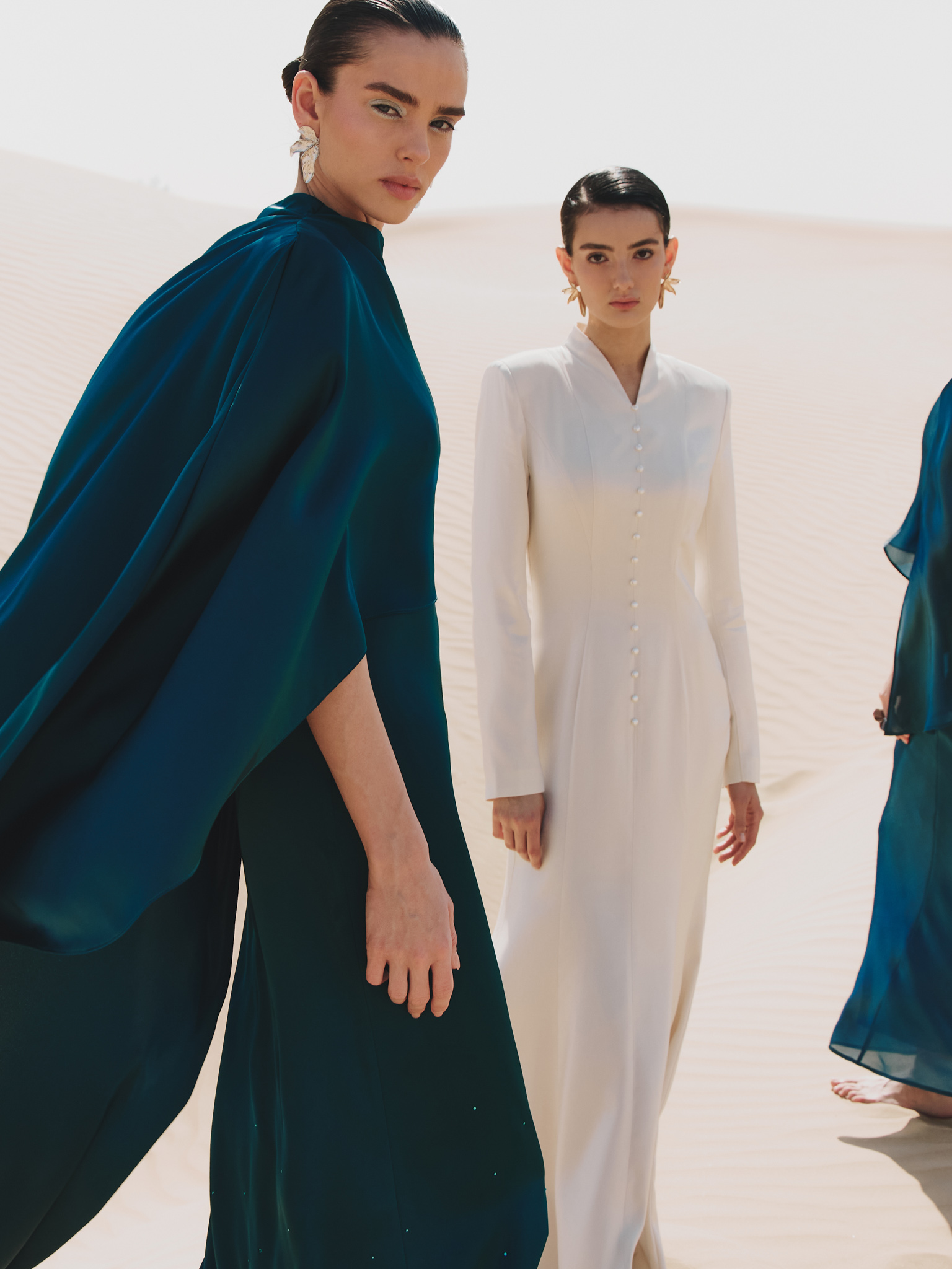 Maxi dress with asymmetrical cape and rhinestones on the skirt