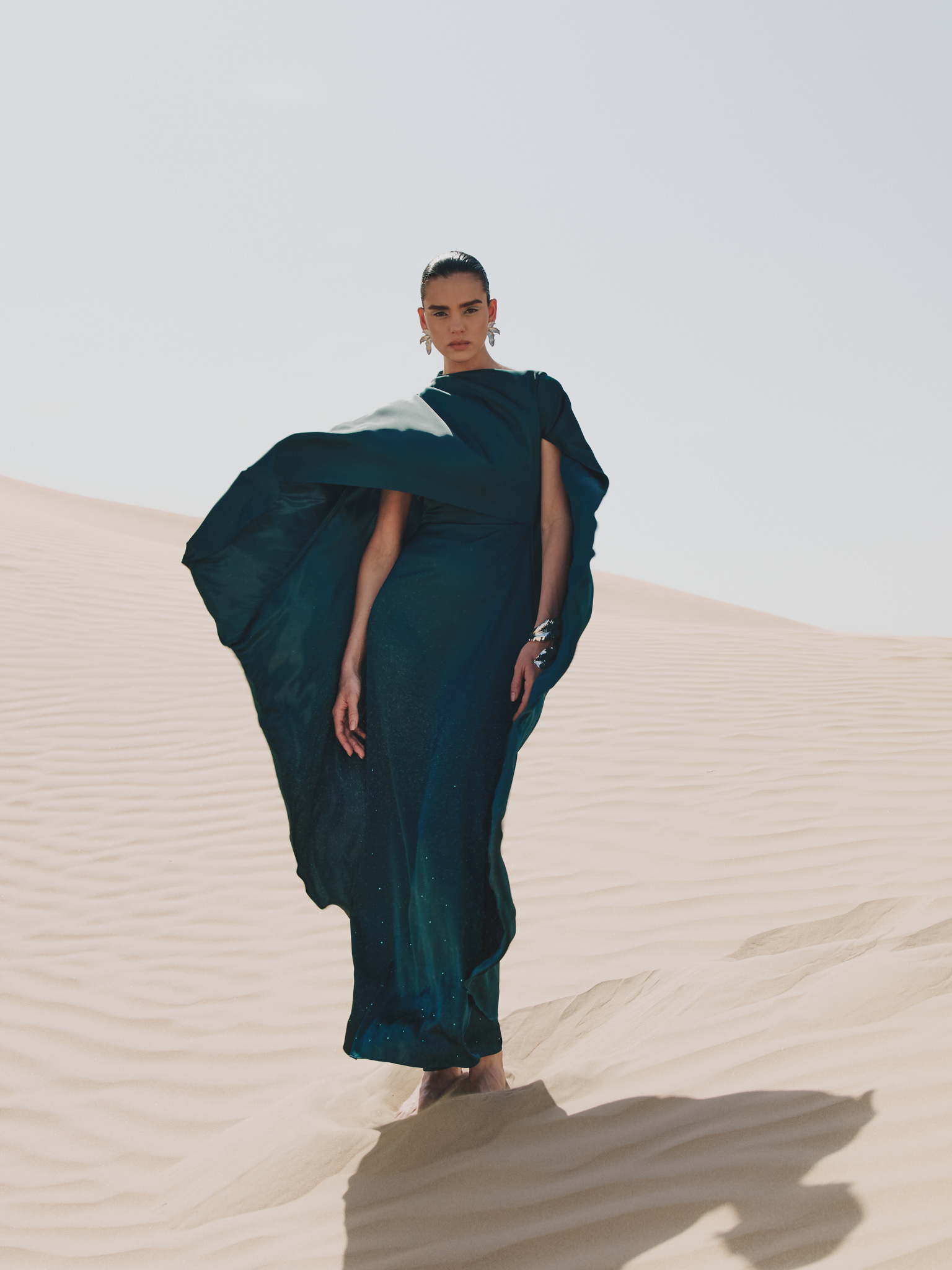 Maxi dress with asymmetrical cape and rhinestones on the skirt