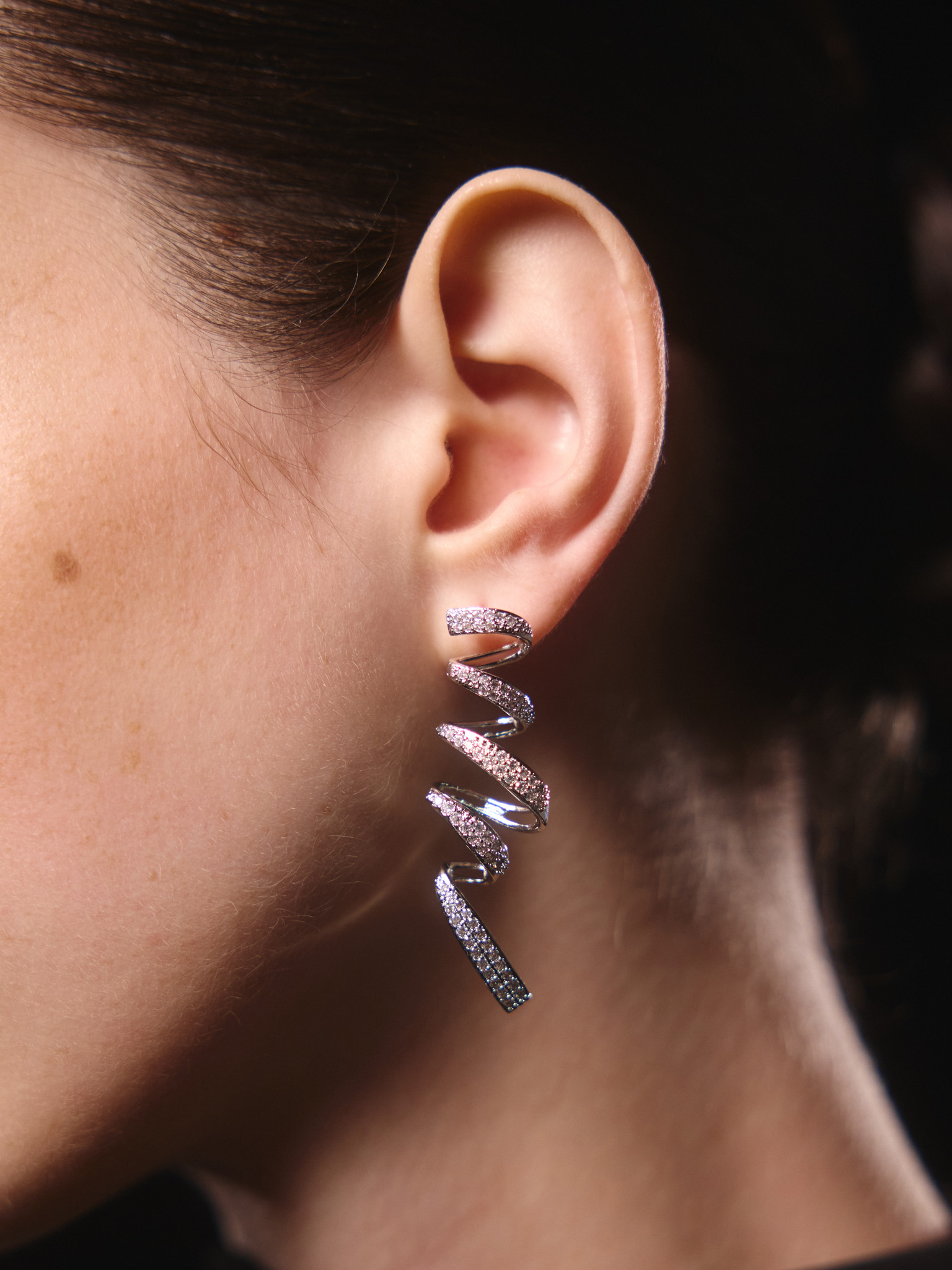 Stud earrings in the form of rhinestone spirals