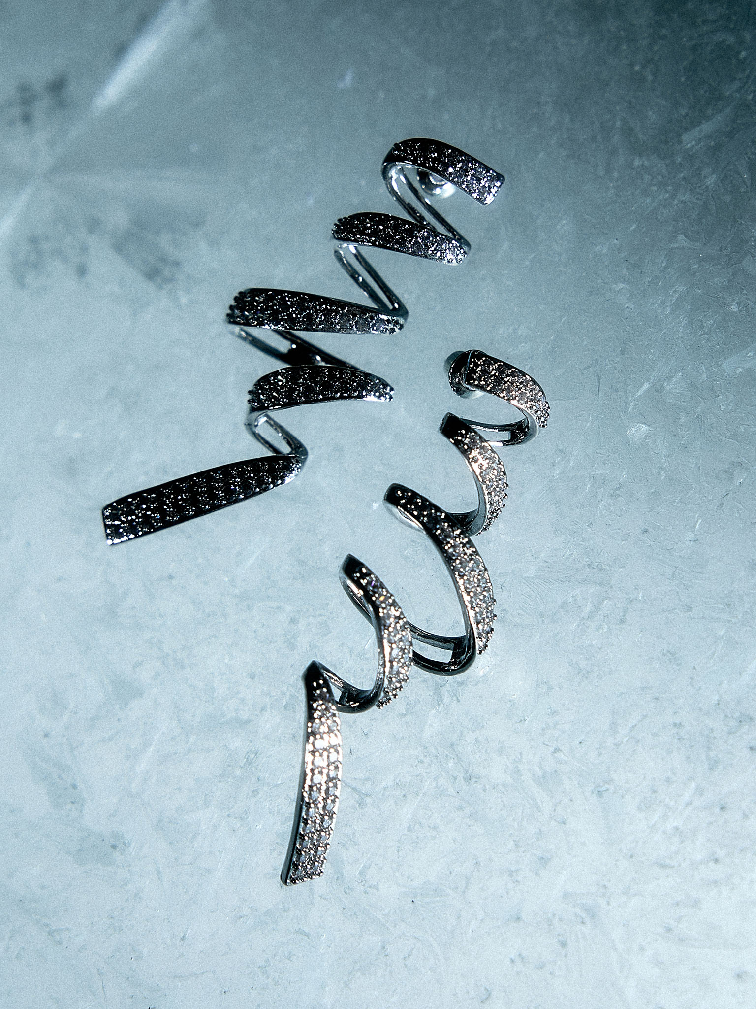 Stud earrings in the form of rhinestone spirals