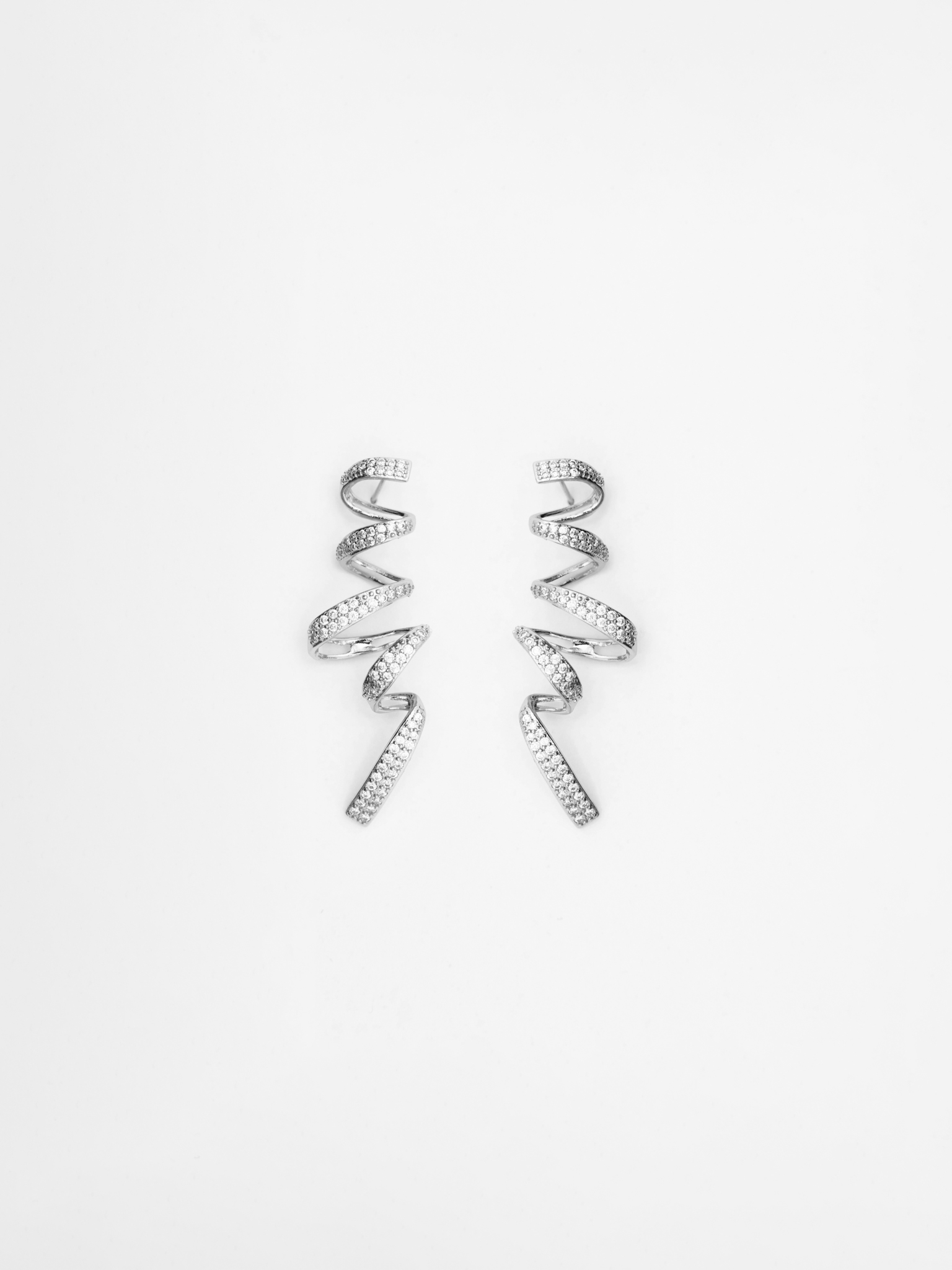 Stud earrings in the form of rhinestone spirals