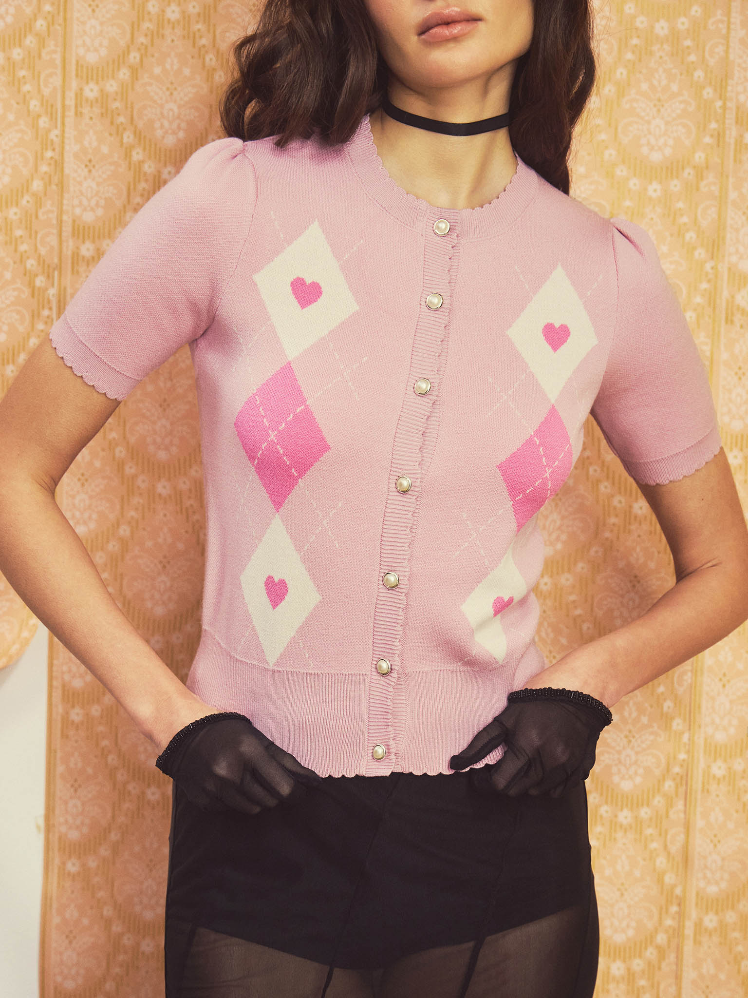 Knitted cardigan with short sleeves and contrasting ornamental pattern