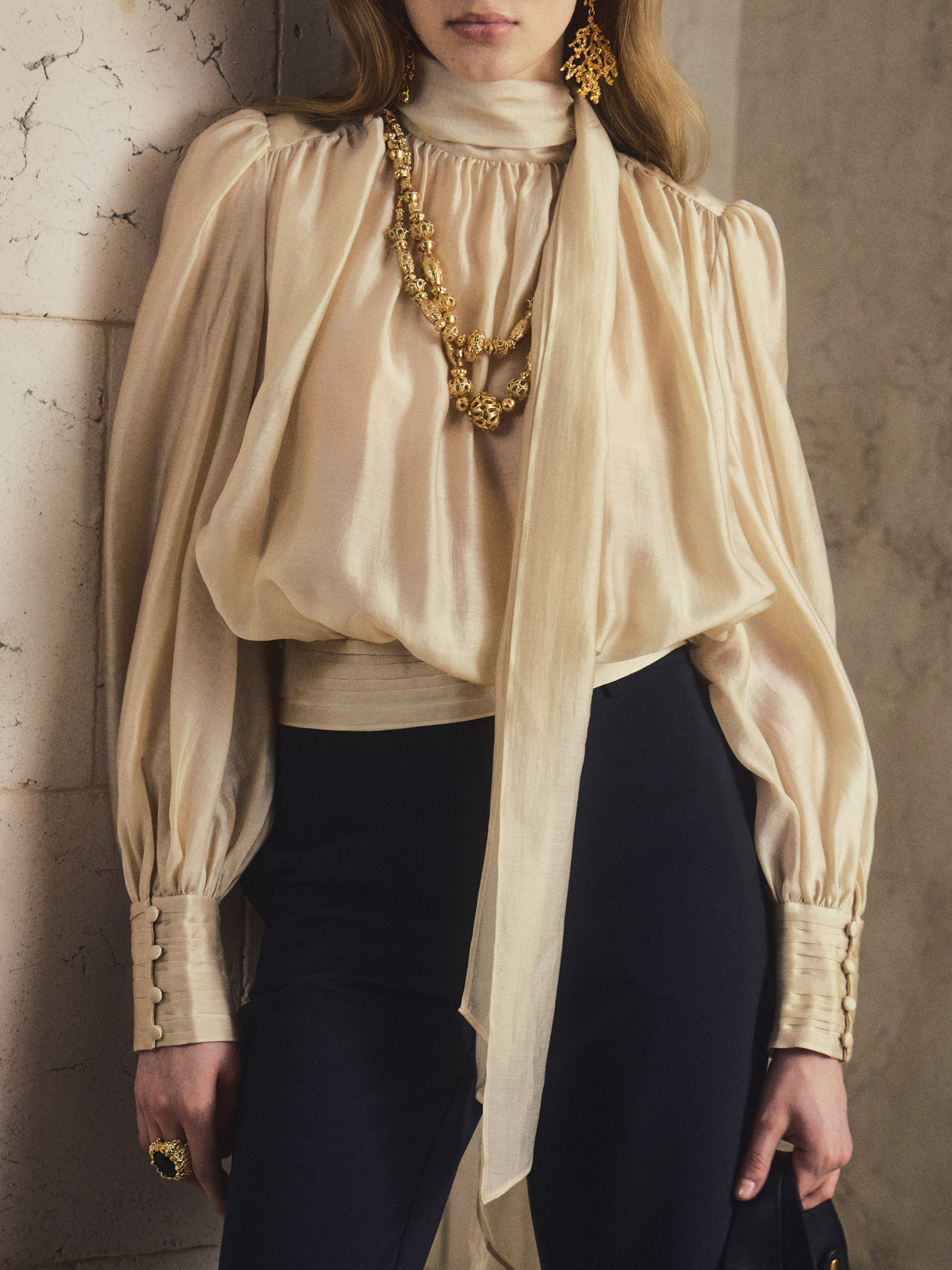 Voluminous blouse with draping at the waist and a ribbon scarf
