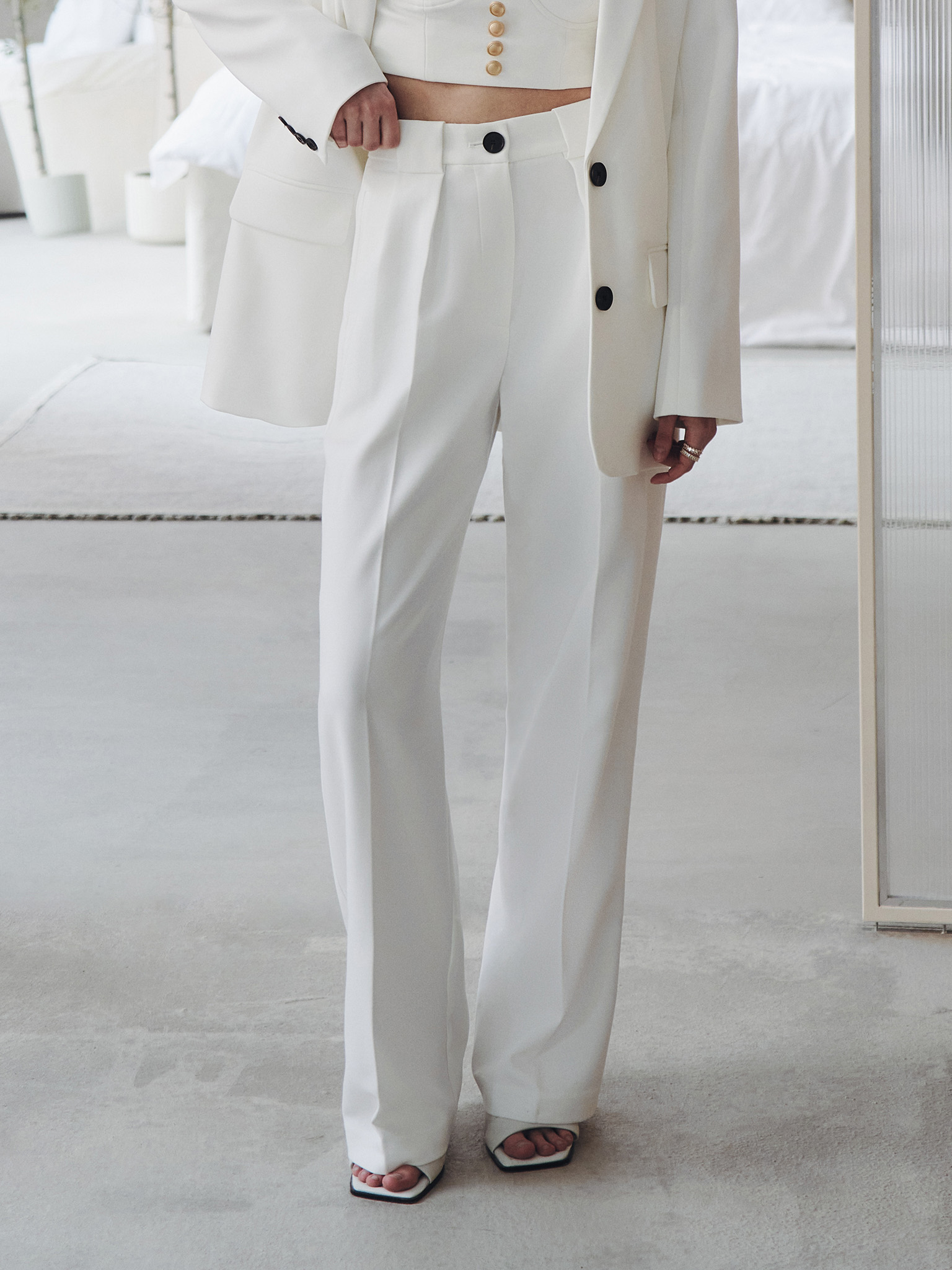 Palazzo trousers with pleats at the waist and contrasting button