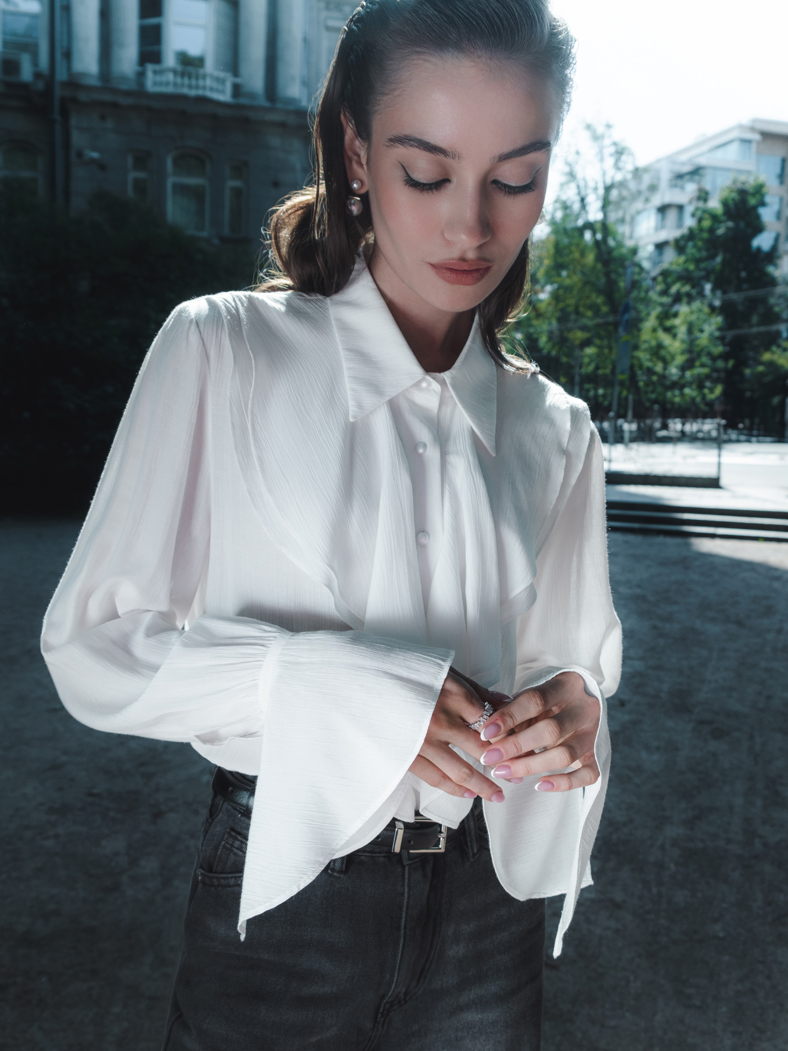 Blouse with voluminous flounces and button fastening