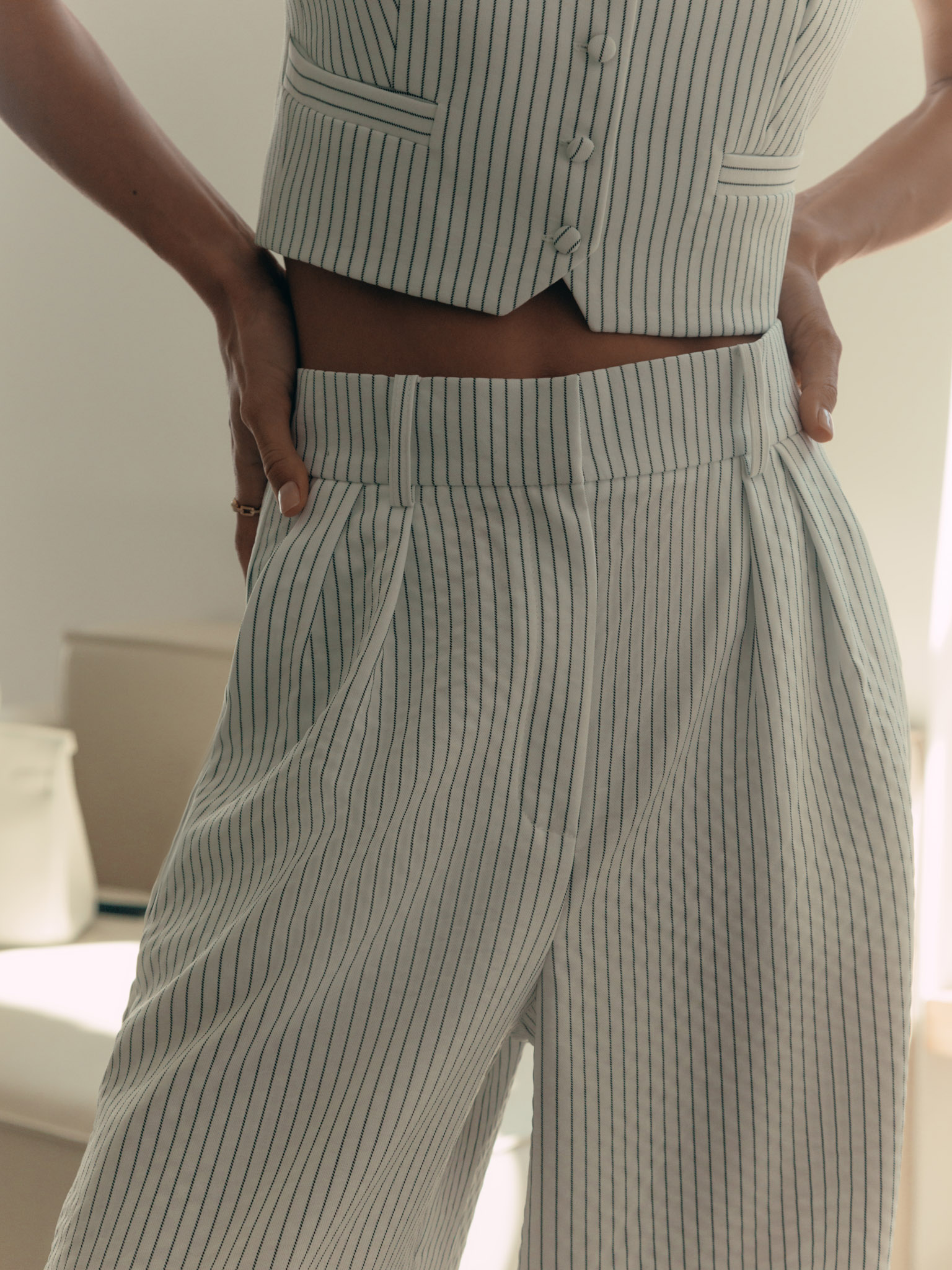 Thin-striped trousers with waist pleats