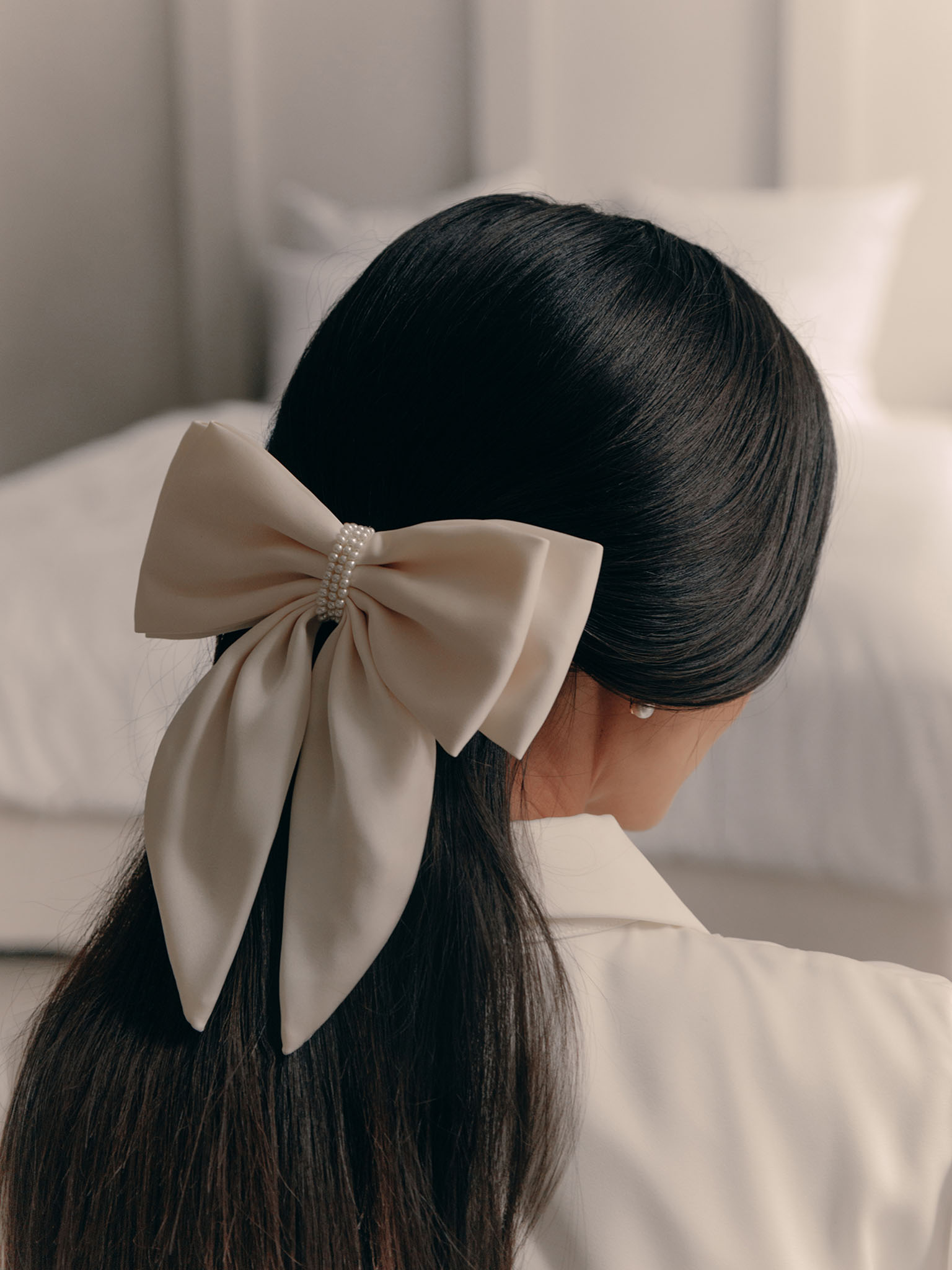 Satin hair bow with pearl decor