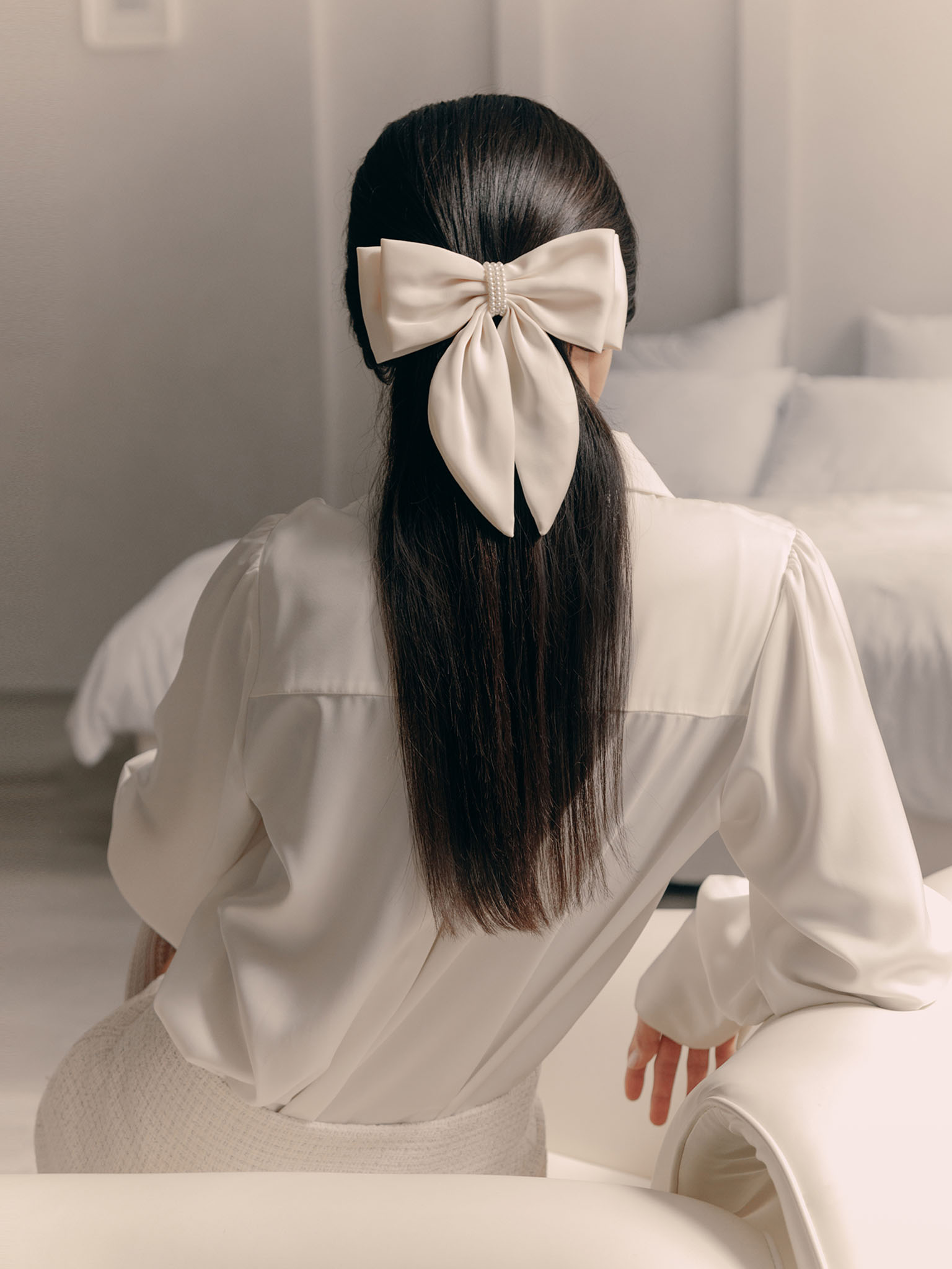 Satin hair bow with pearl decor