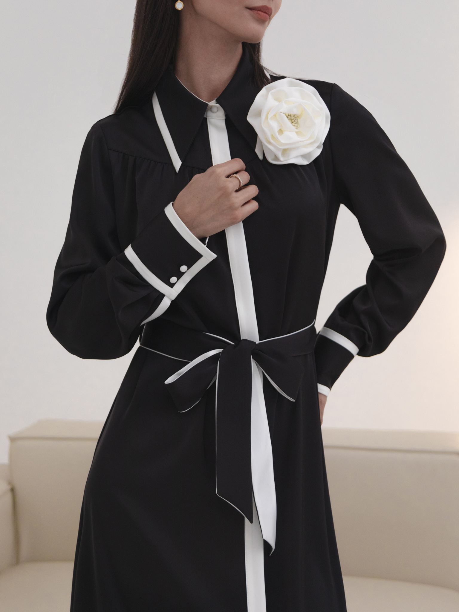 Maxi dress with contrasting inserts and flower brooch