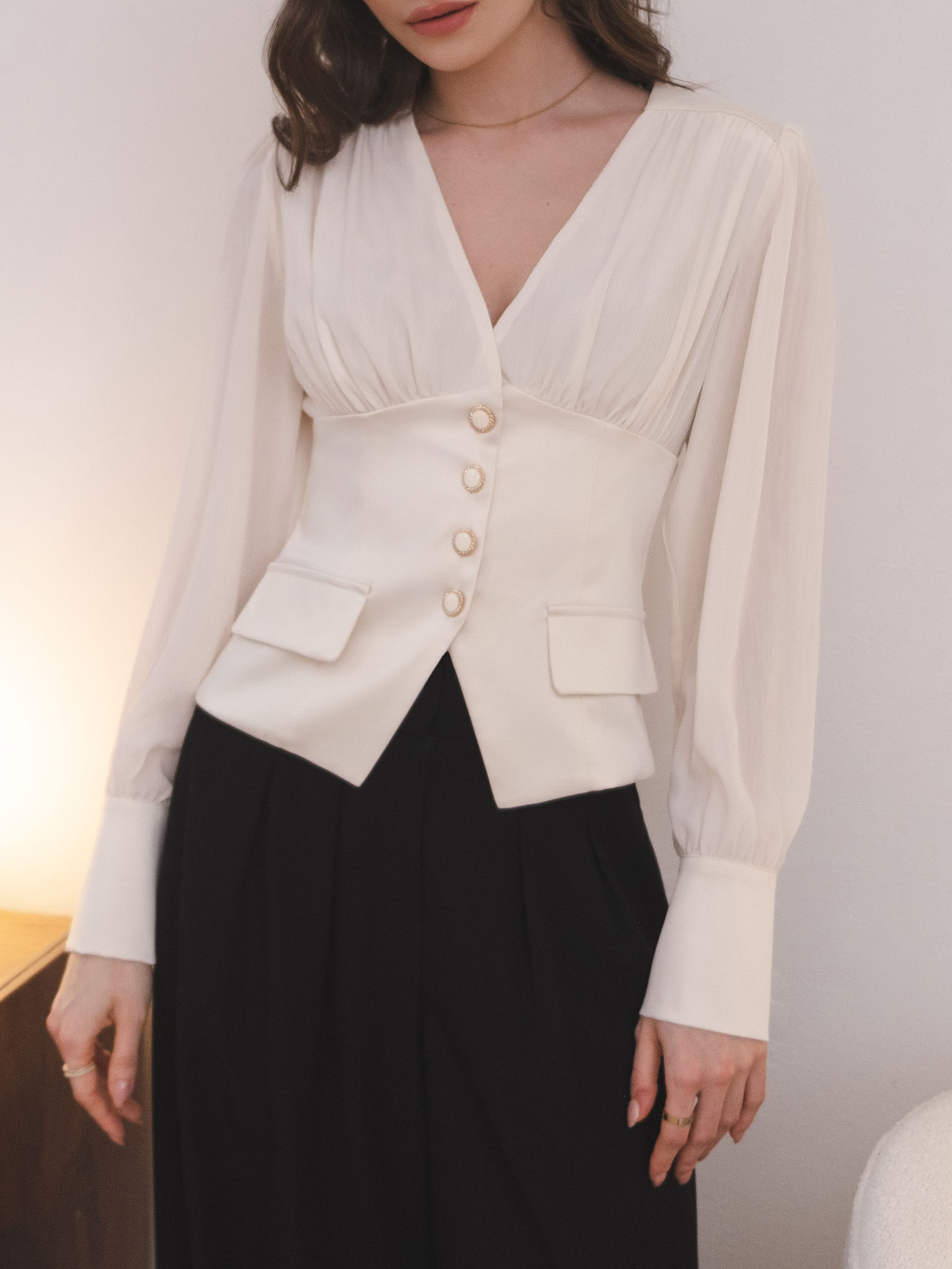 Blouse with a waistband and large button fastening