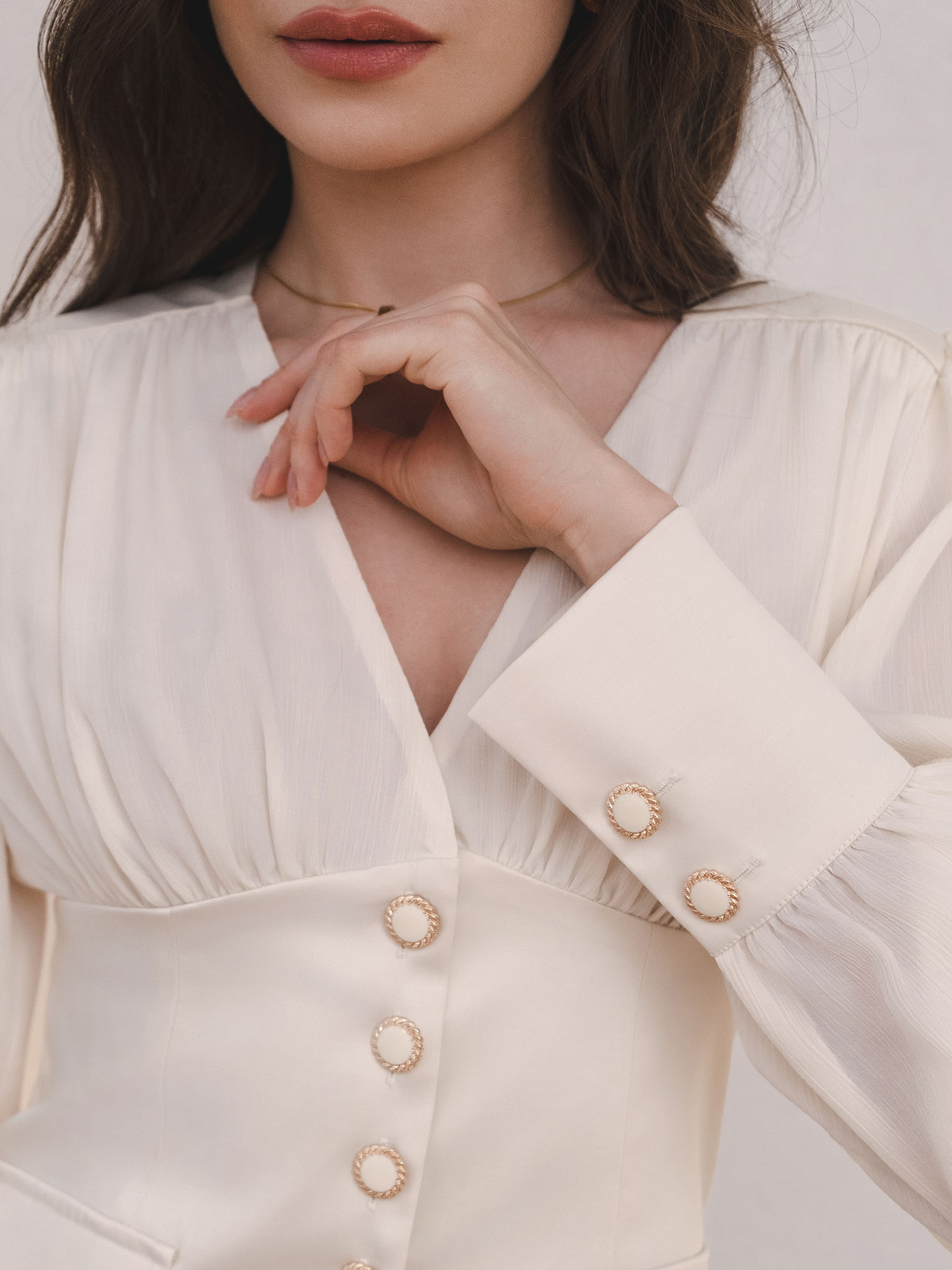 Blouse with a waistband and large button fastening