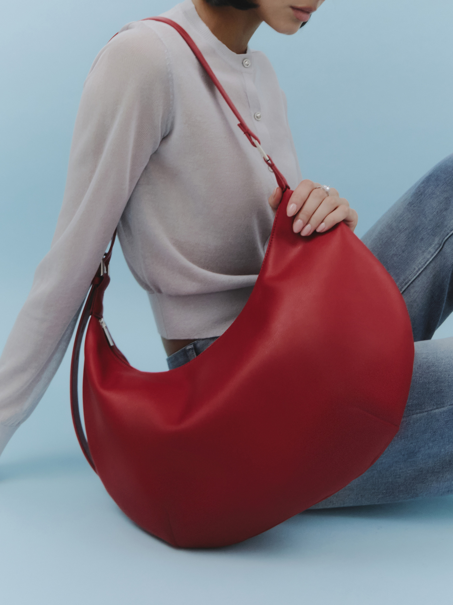 Semi-circular eco-leather bag with wide strap