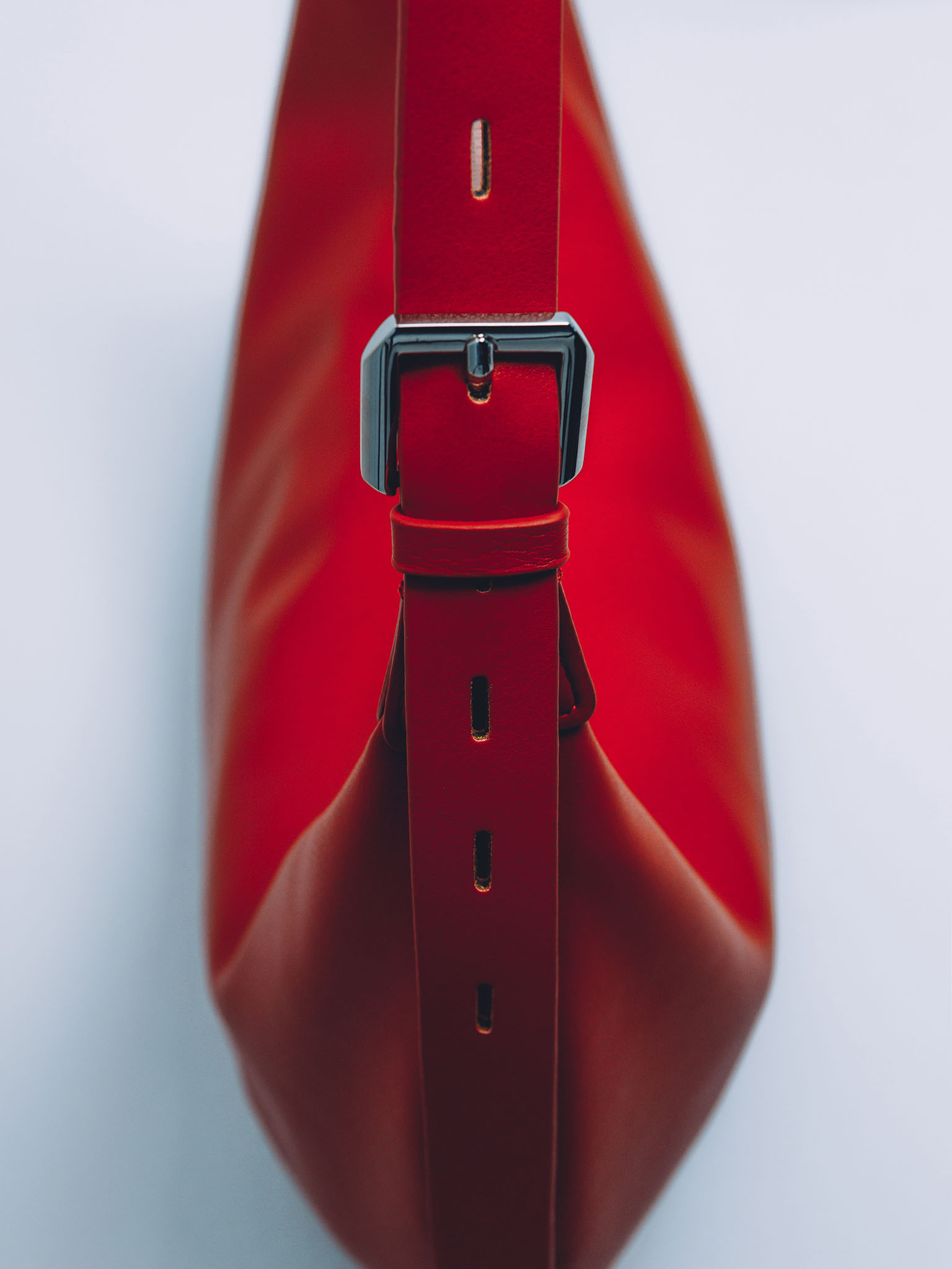 Semi-circular eco-leather bag with wide strap