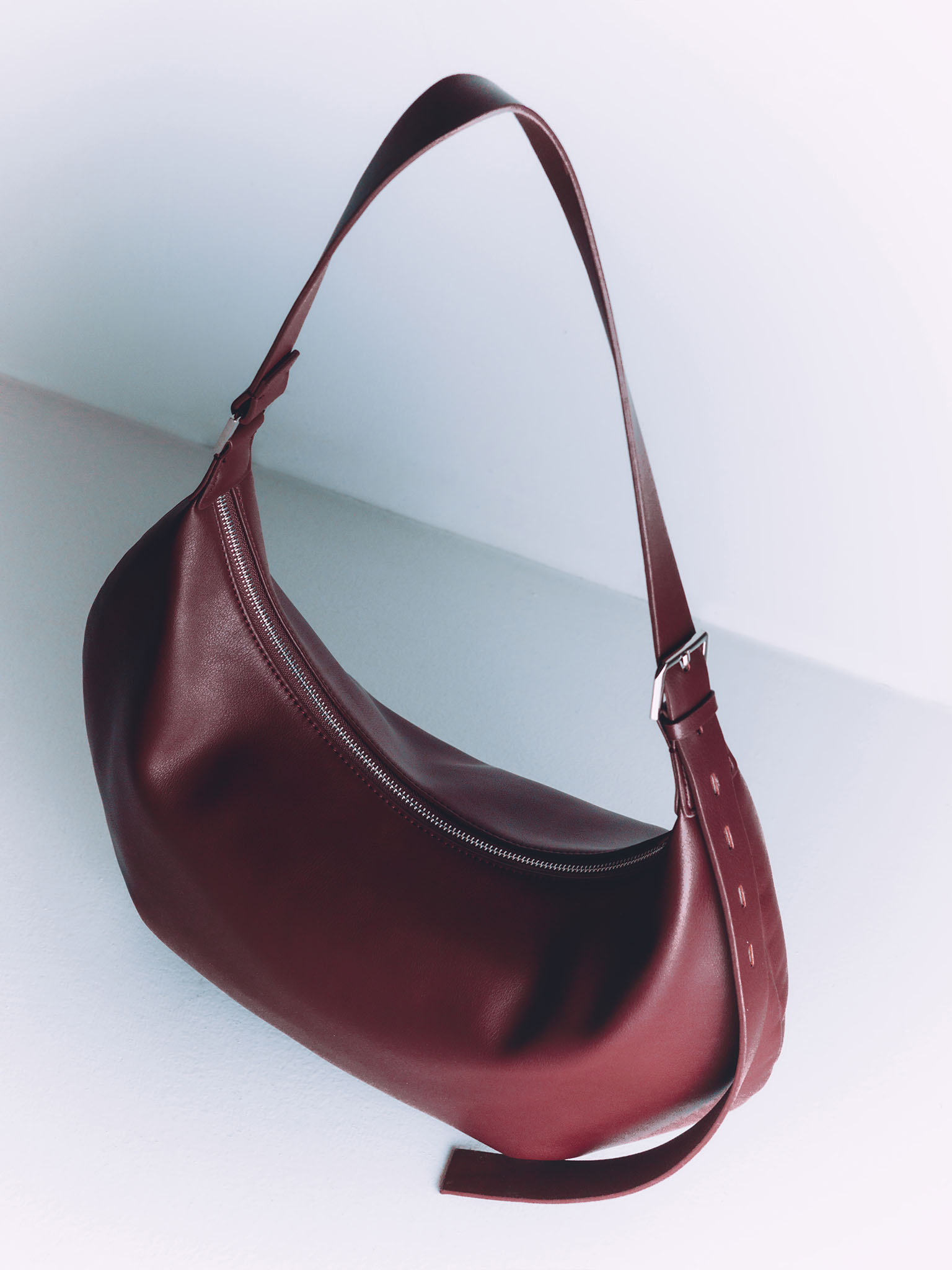 Semi-circular eco-leather bag with wide strap