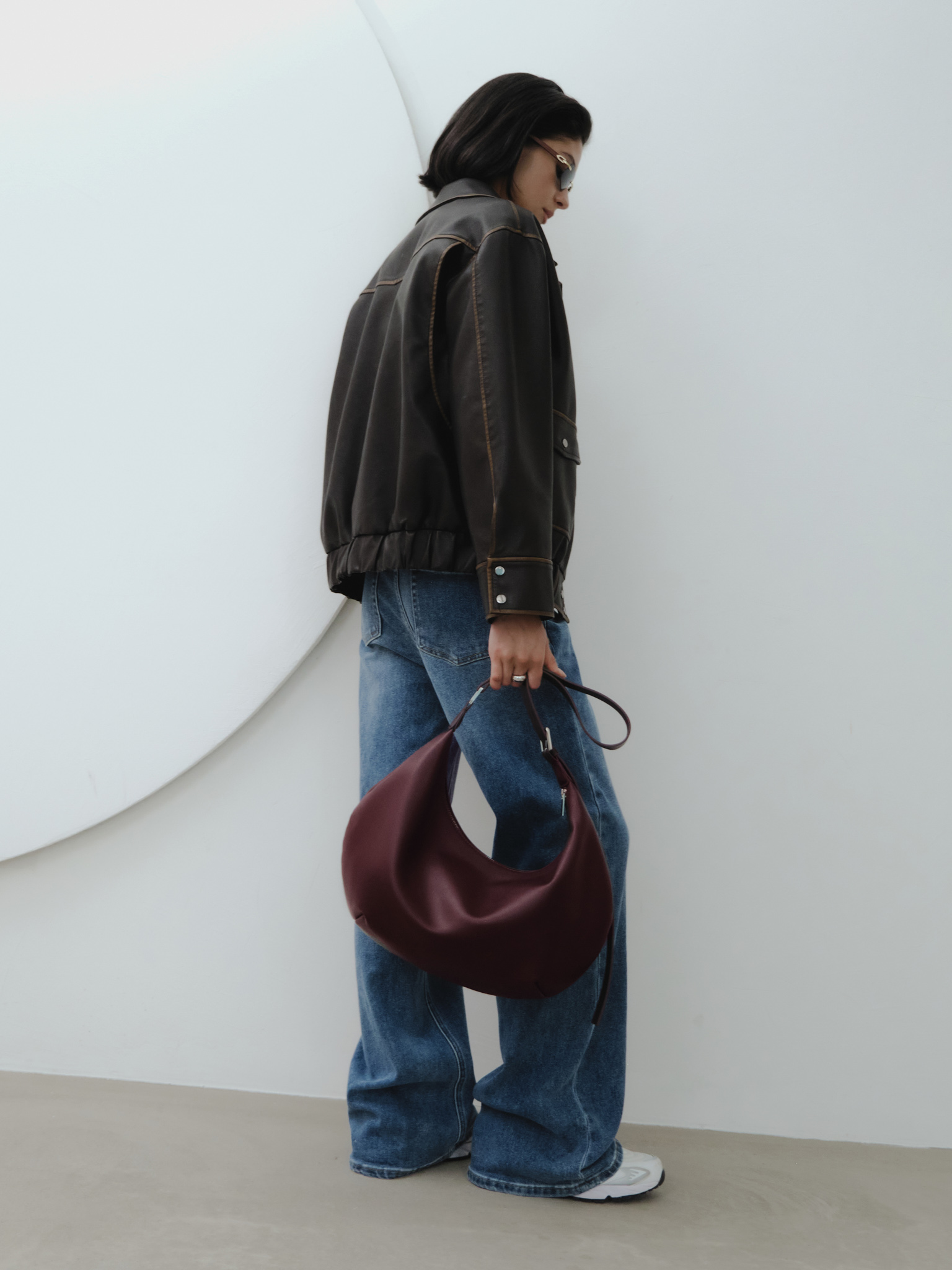 Semi-circular eco-leather bag with wide strap