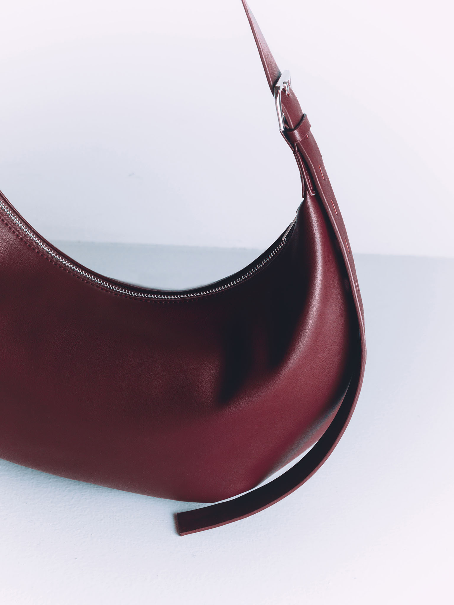 Semi-circular eco-leather bag with wide strap