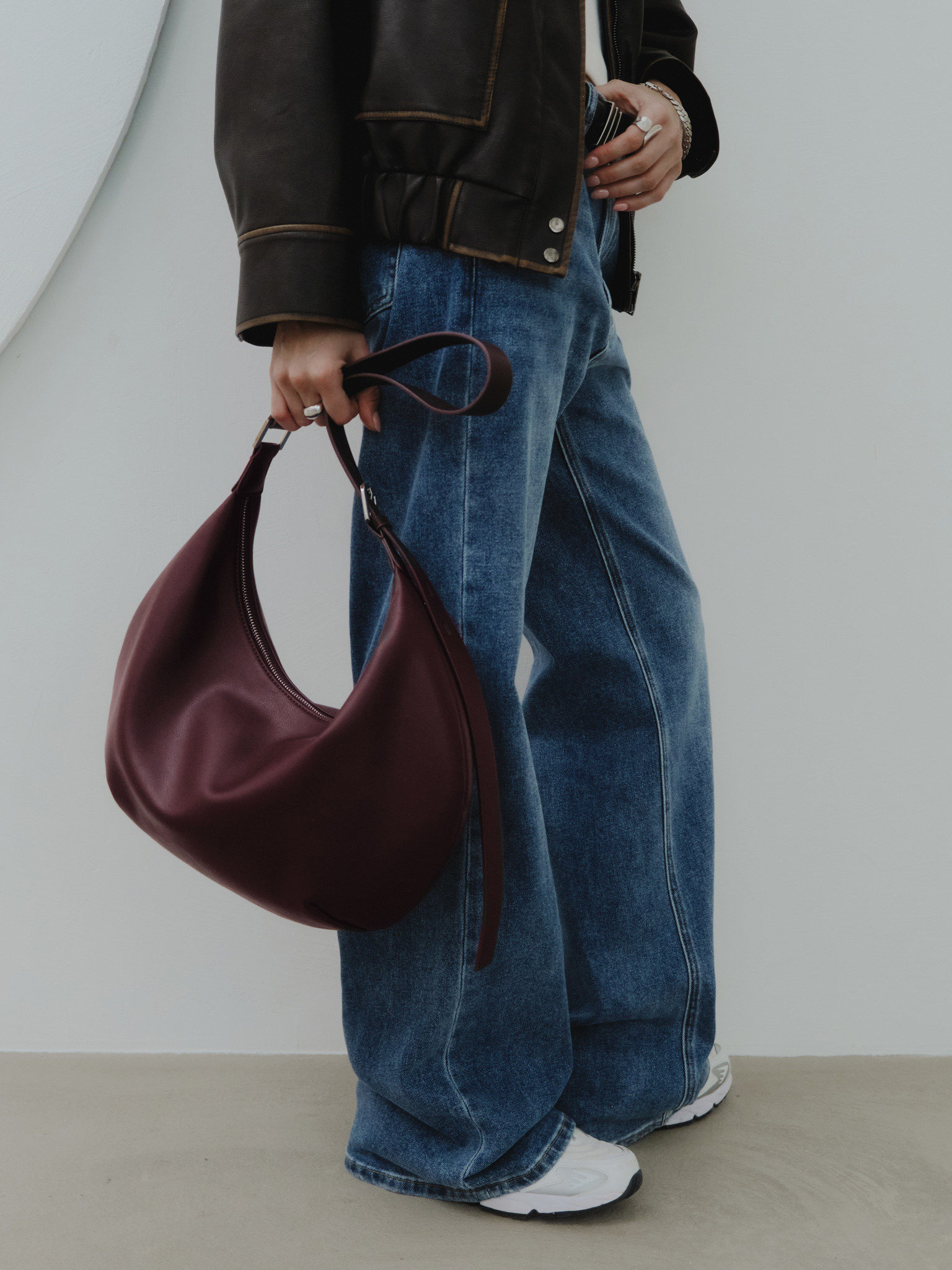 Semi-circular eco-leather bag with wide strap