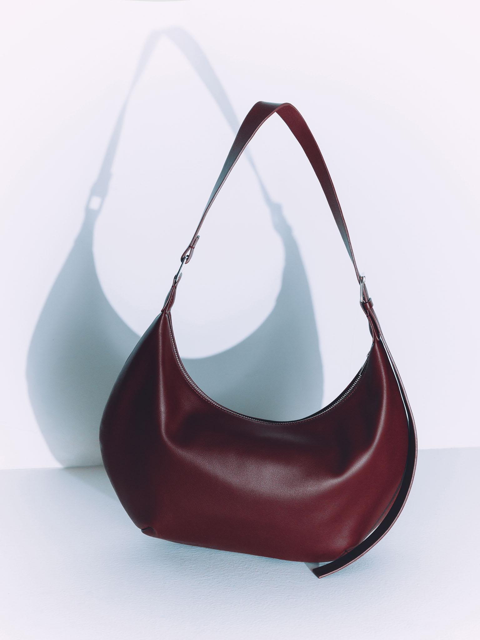 Semi-circular eco-leather bag with wide strap