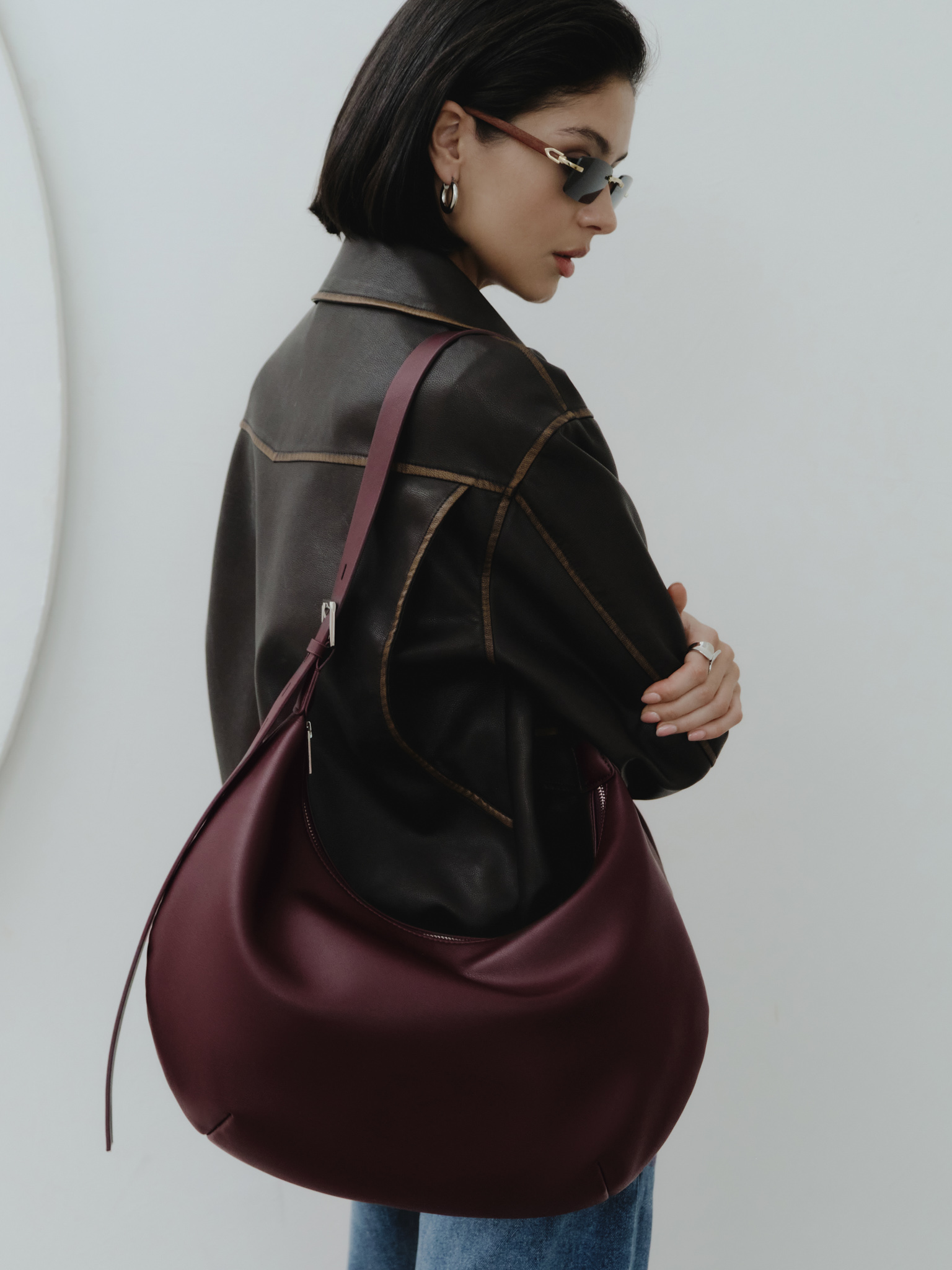 Semi-circular eco-leather bag with wide strap