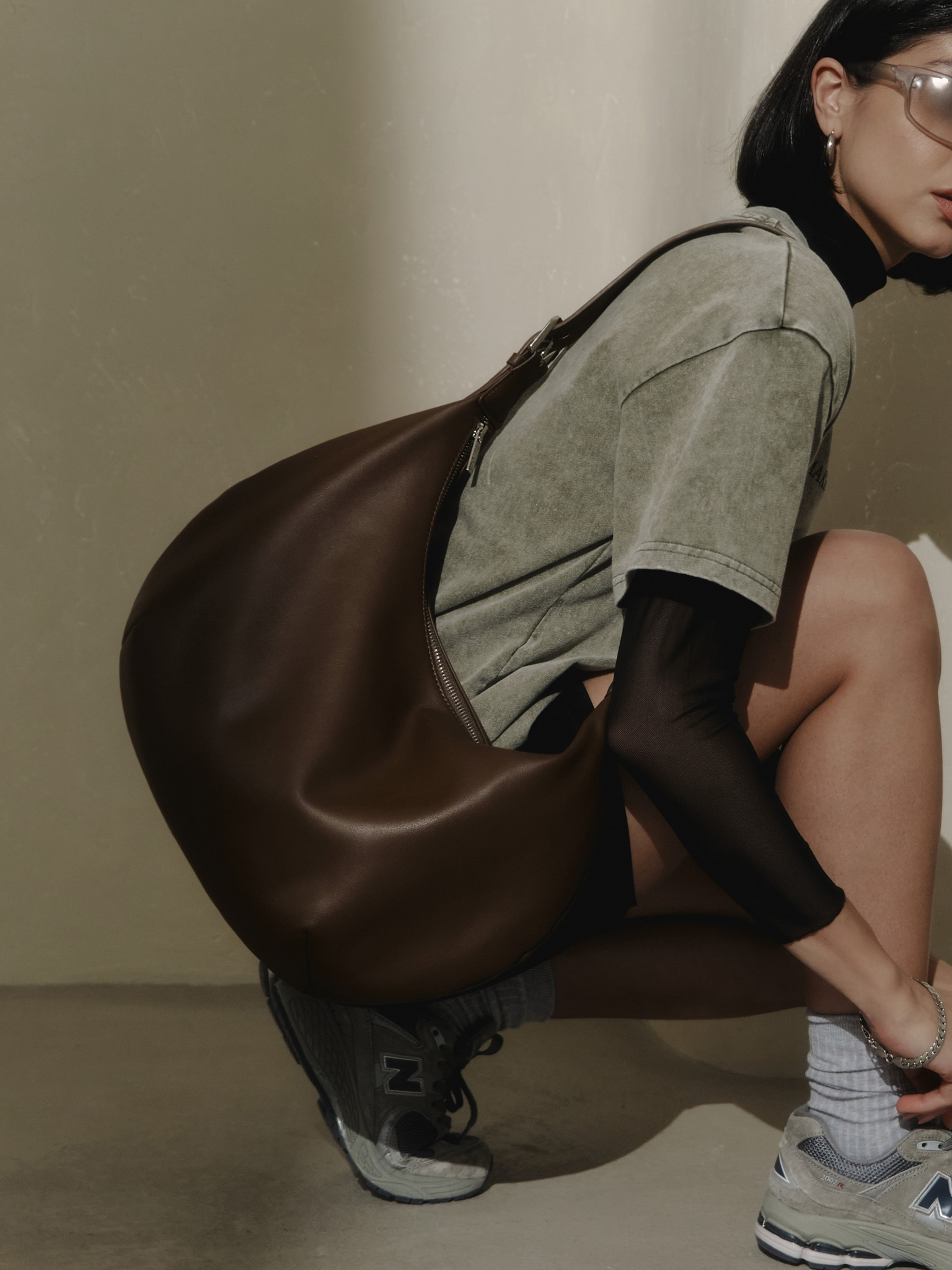 Semi-circular eco-leather bag with wide strap