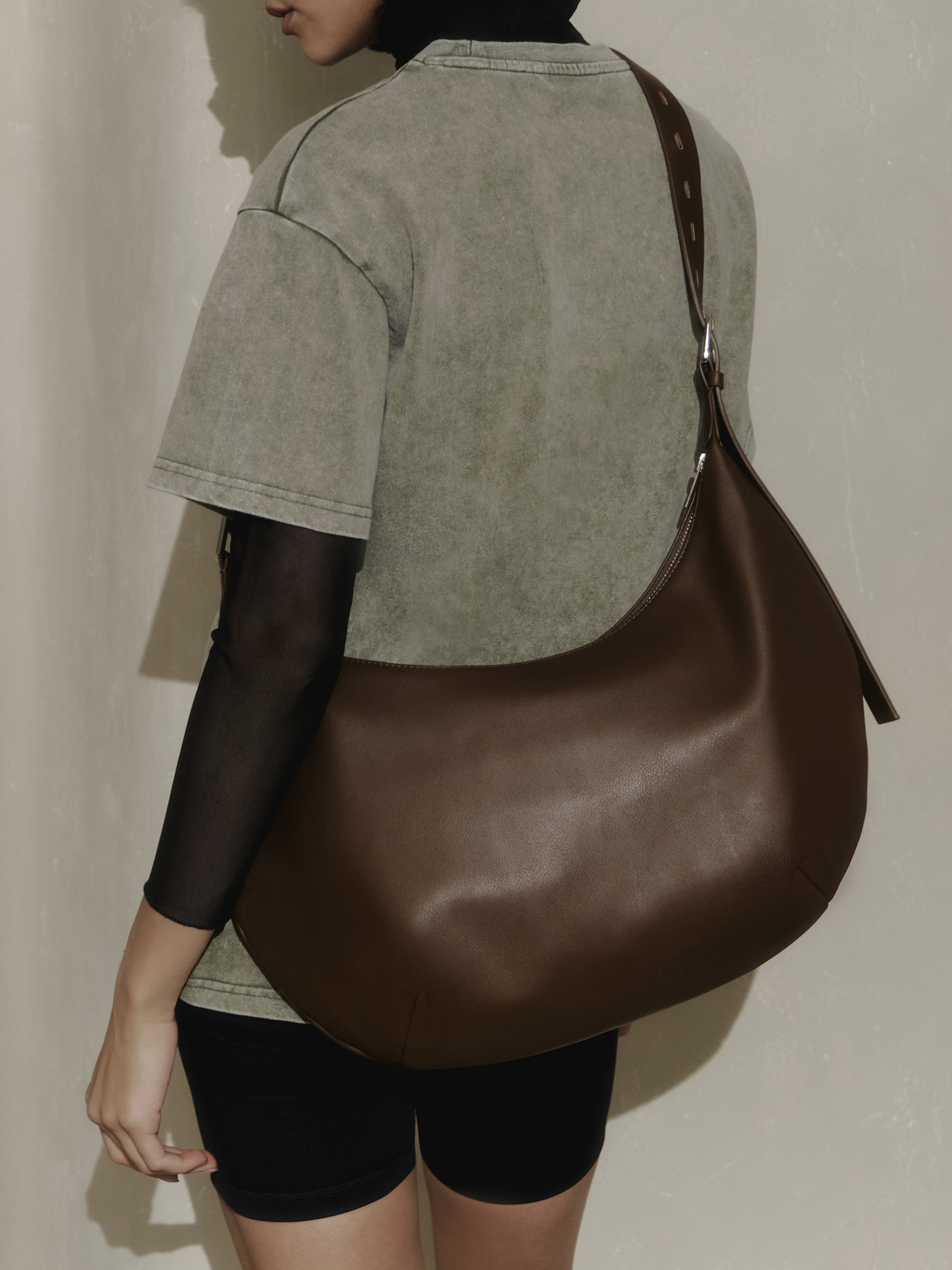 Semi-circular eco-leather bag with wide strap