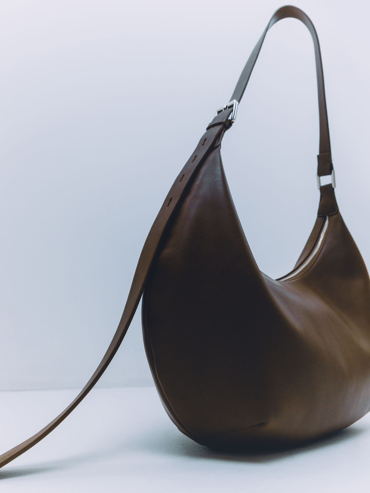 Semi-circular eco-leather bag with wide strap