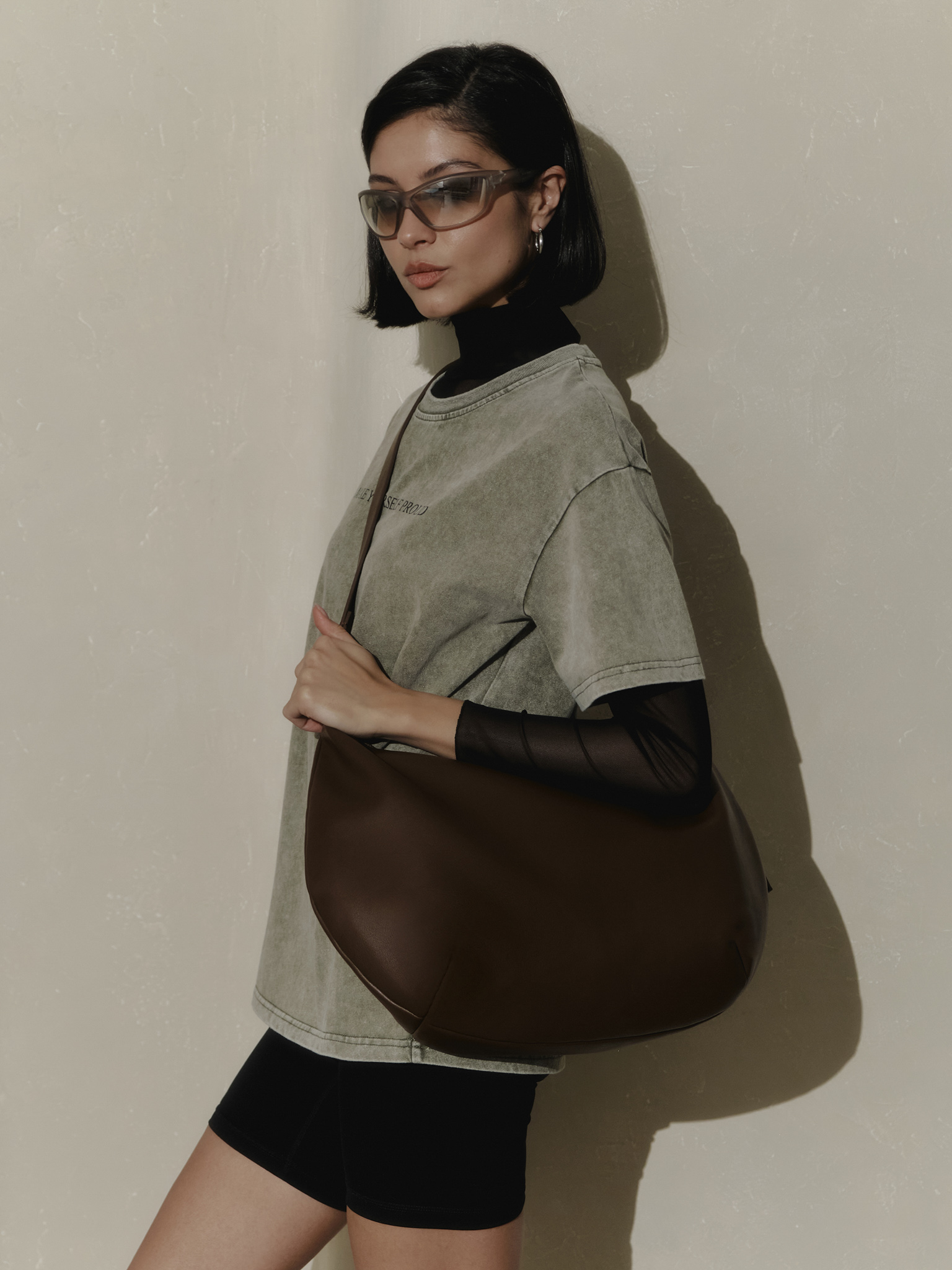 Semi-circular eco-leather bag with wide strap