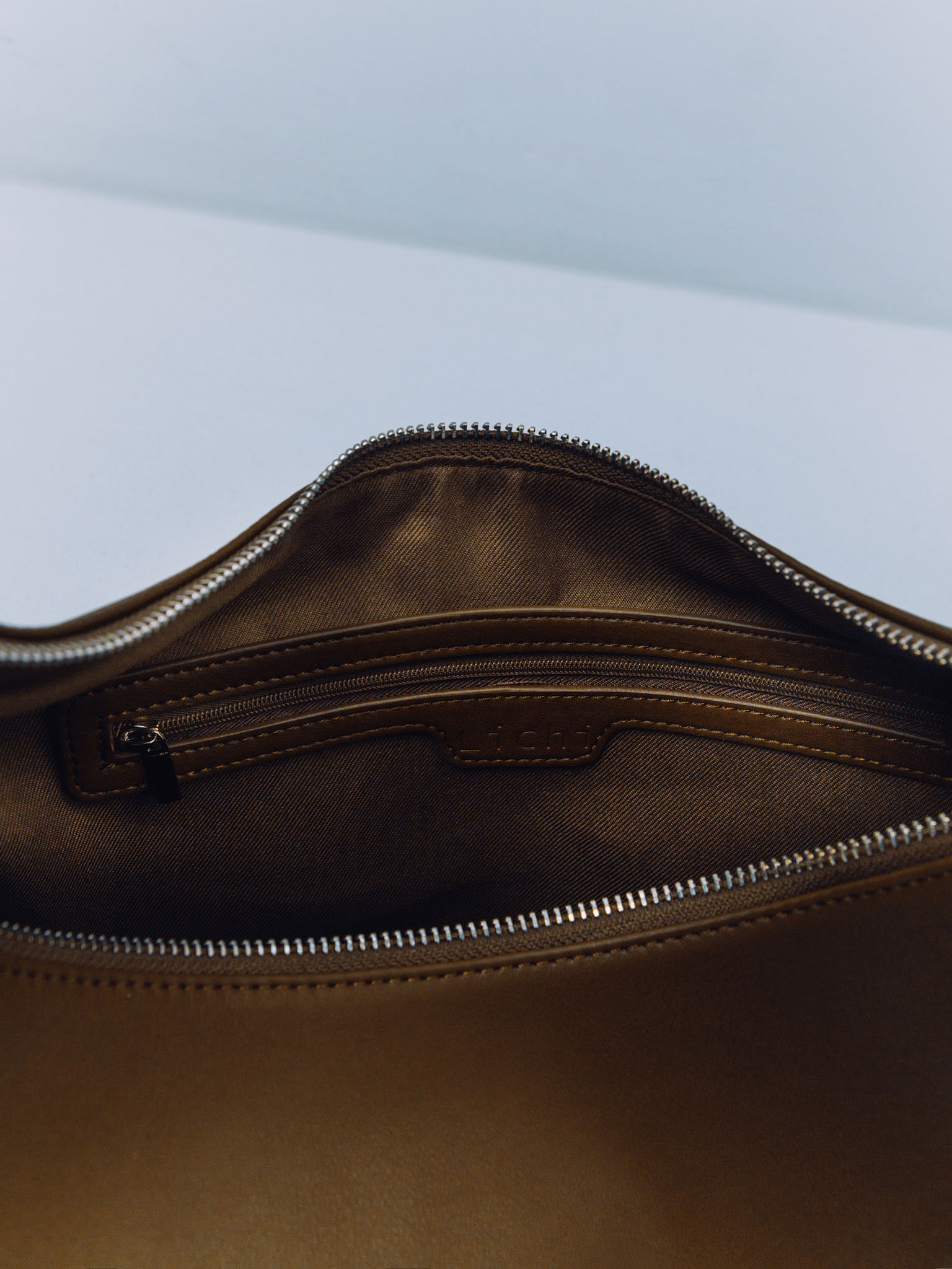 Semi-circular eco-leather bag with wide strap