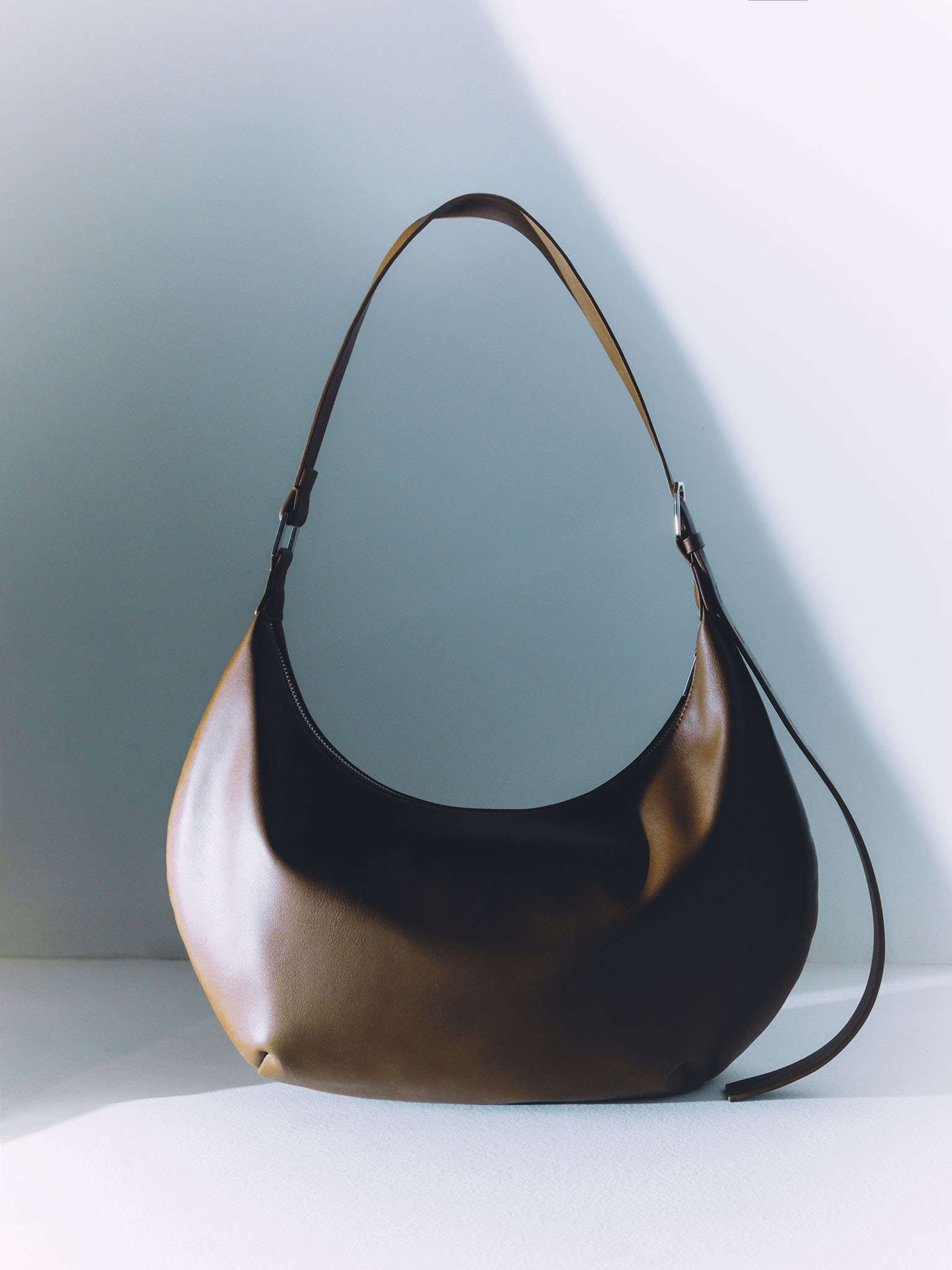 Semi-circular eco-leather bag with wide strap