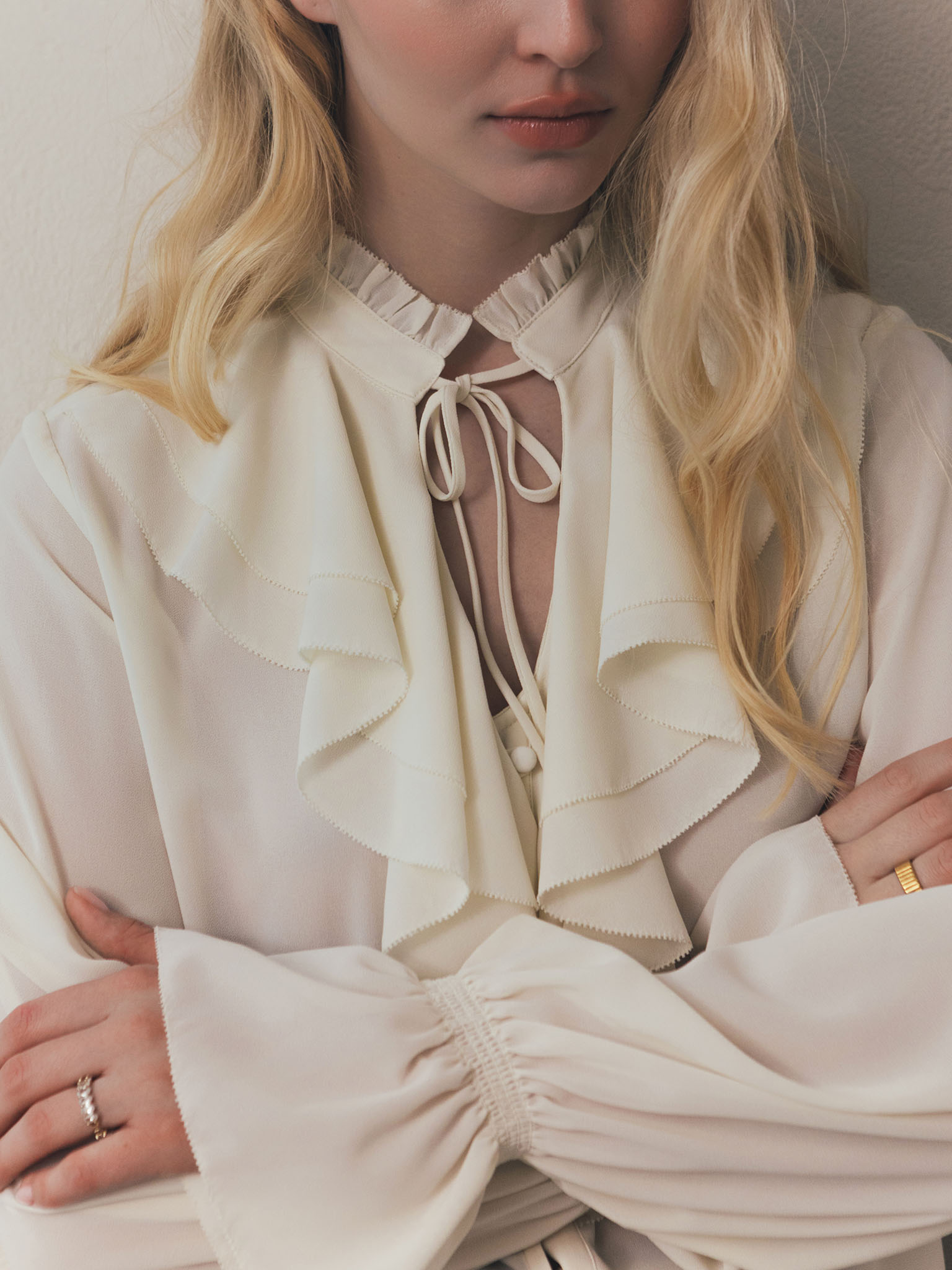 Light blouse with flounces and ties at the collar