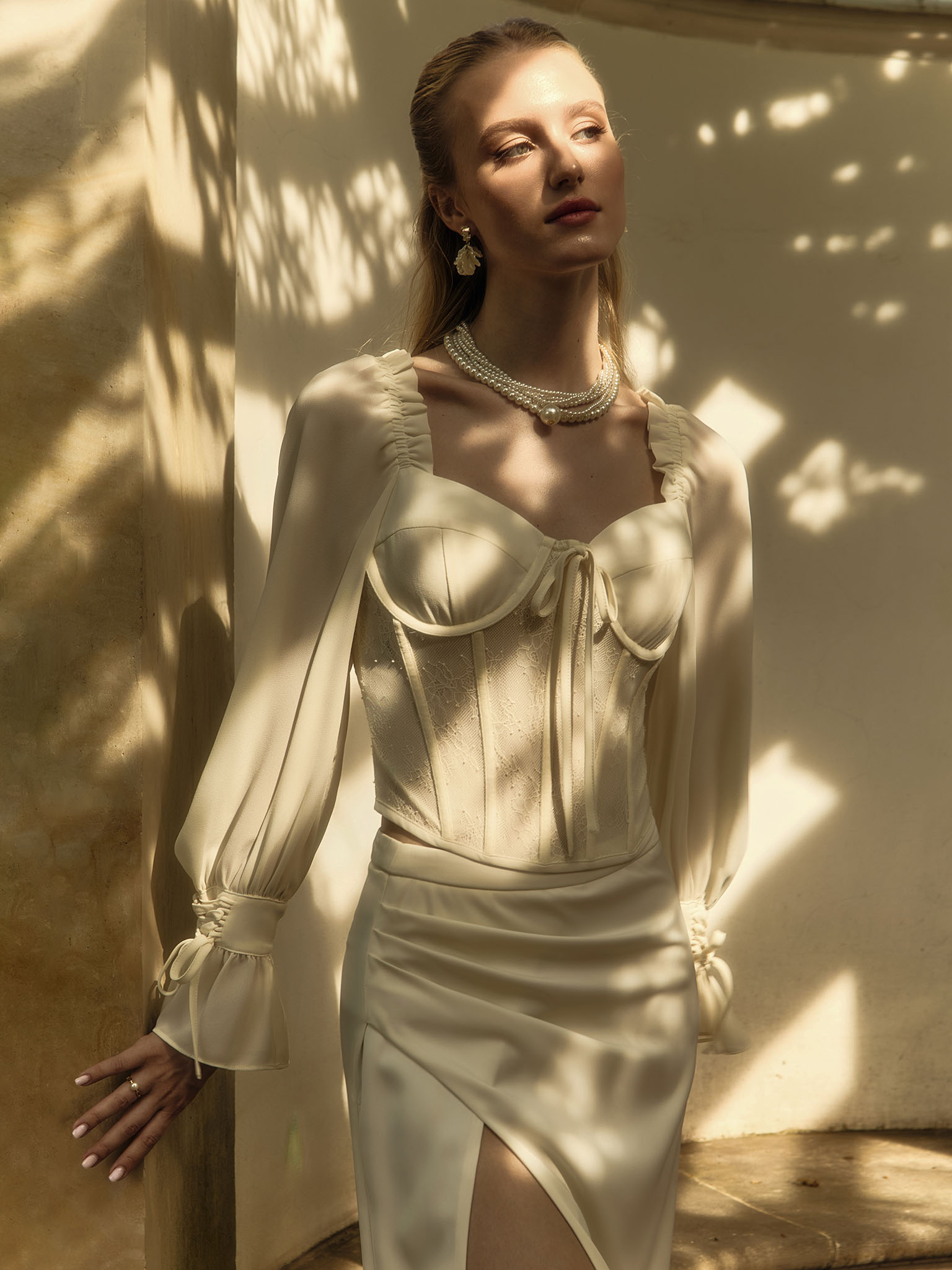 Corset blouse with lace waistband and tie-up cuffs