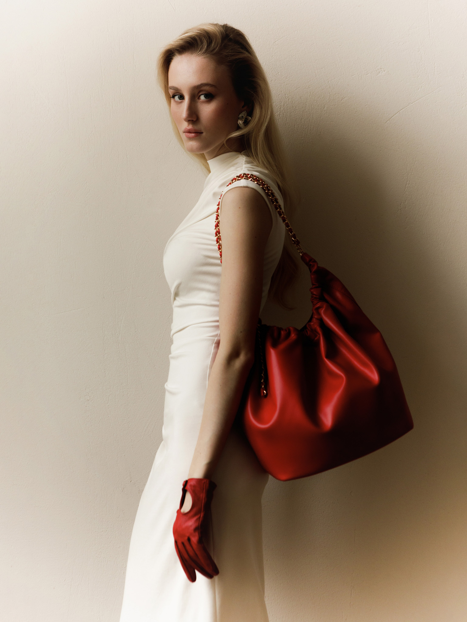 Soft-shaped bag with chain decor on the handles