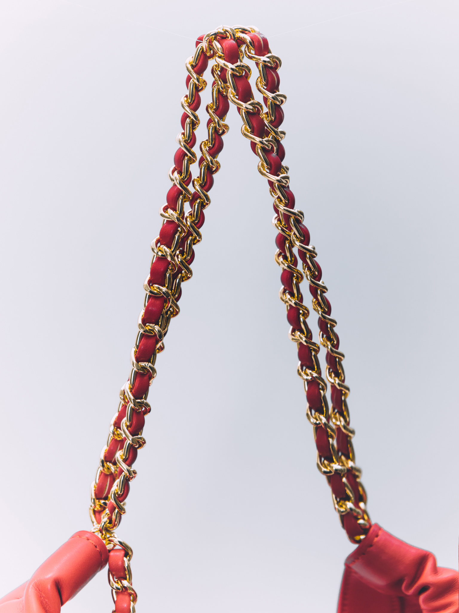Soft-shaped bag with chain decor on the handles