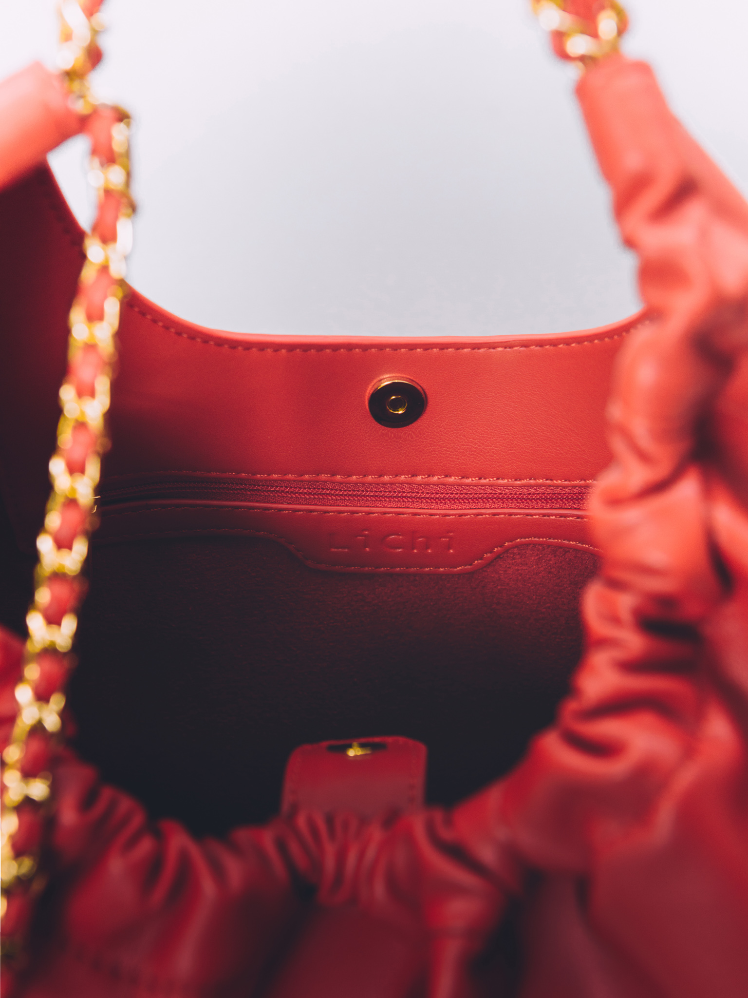 Soft-shaped bag with chain decor on the handles