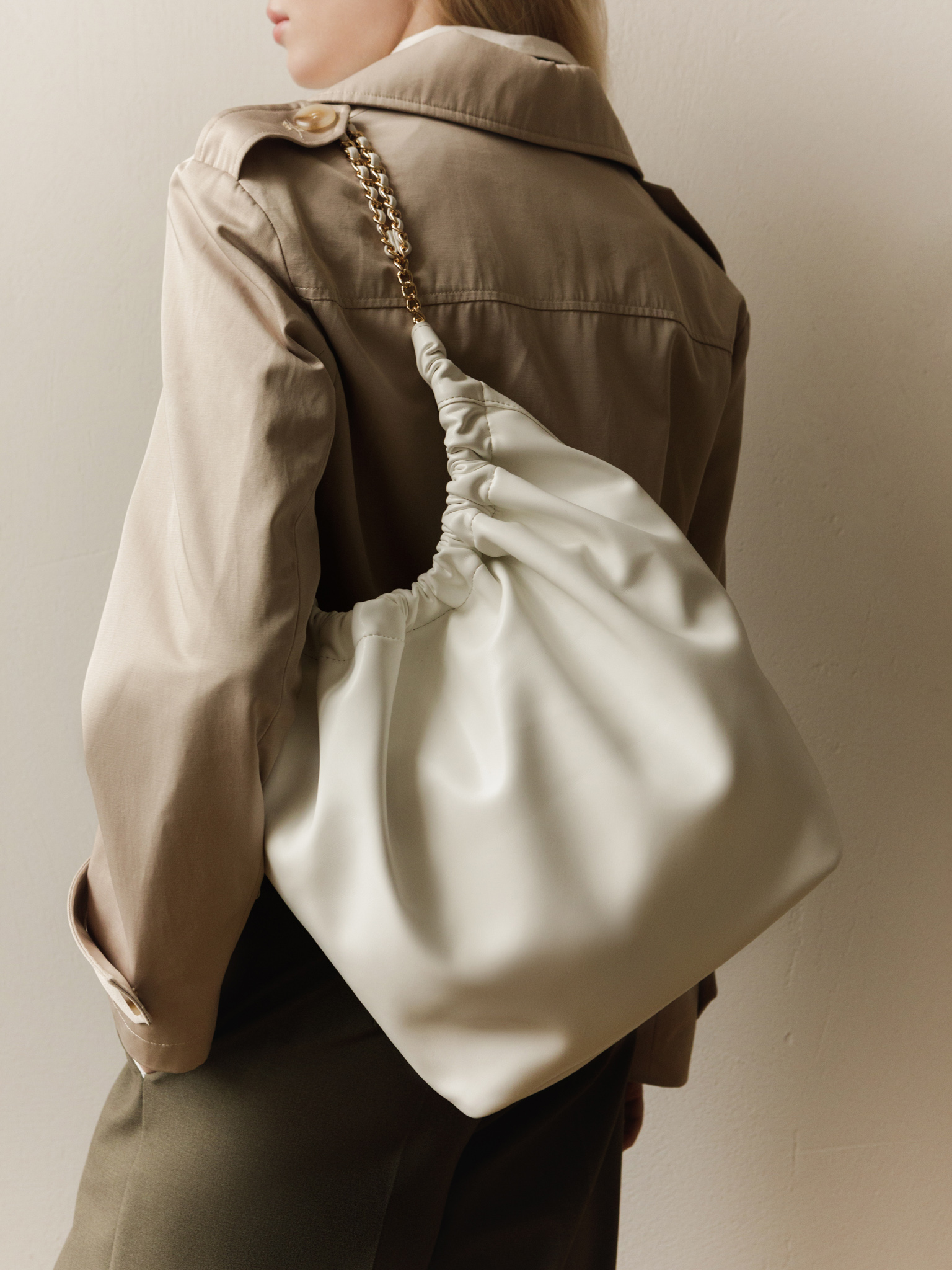 Soft-shaped bag with chain decor on the handles