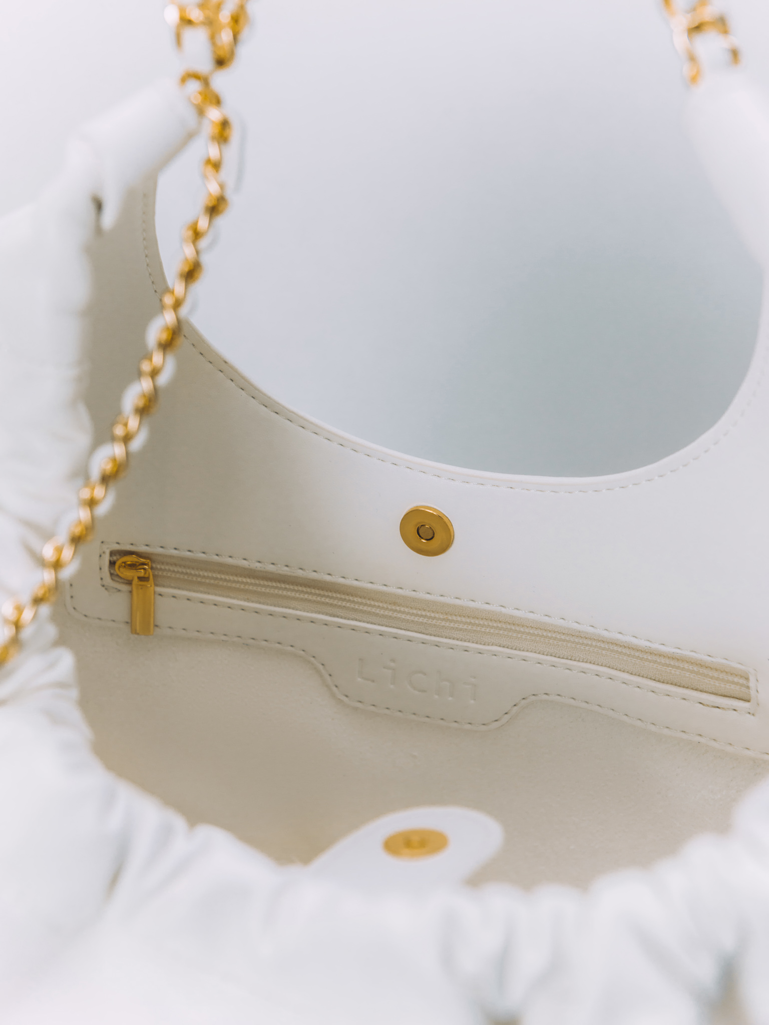 Soft-shaped bag with chain decor on the handles