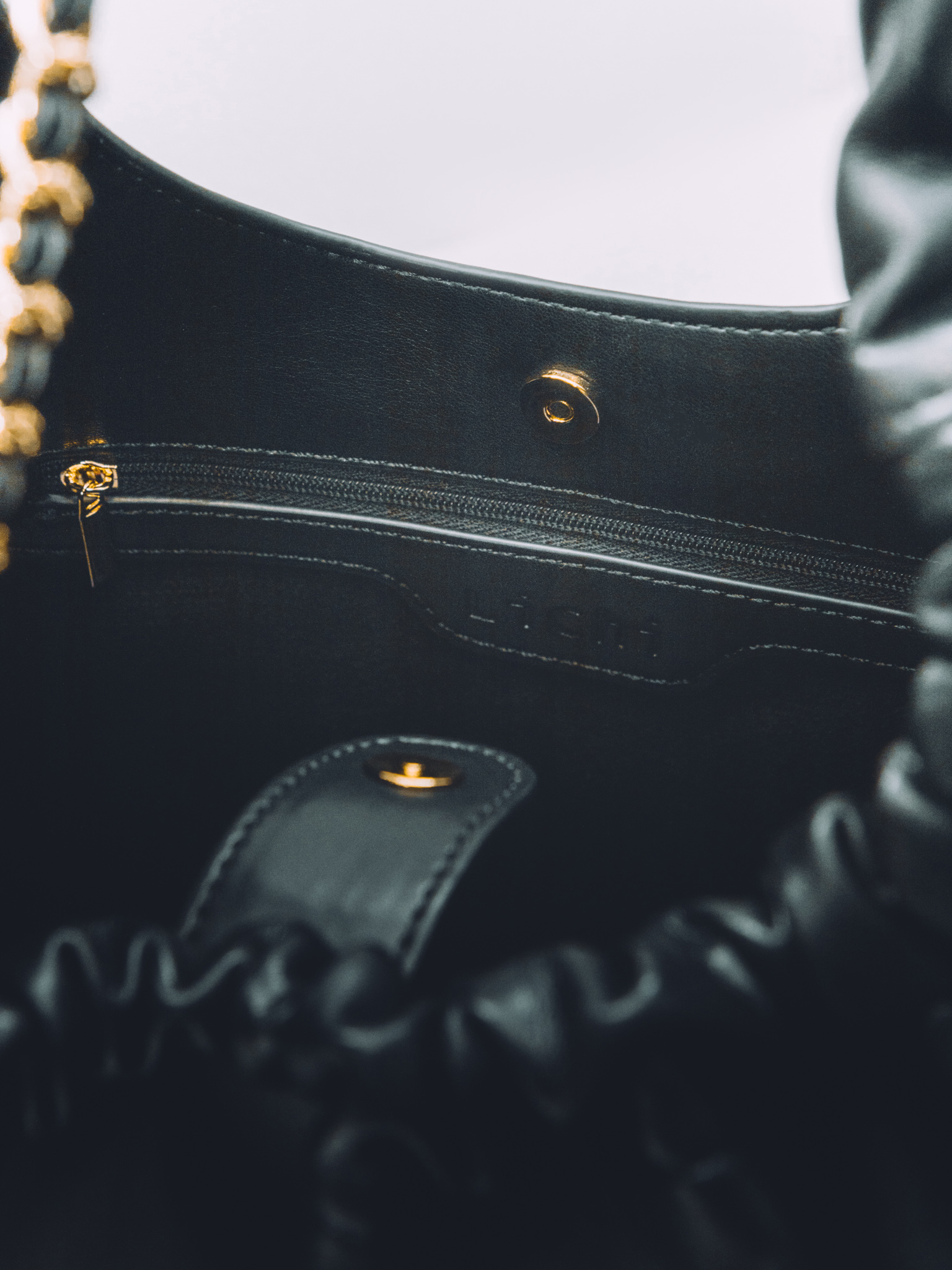 Soft-shaped bag with chain decor on the handles