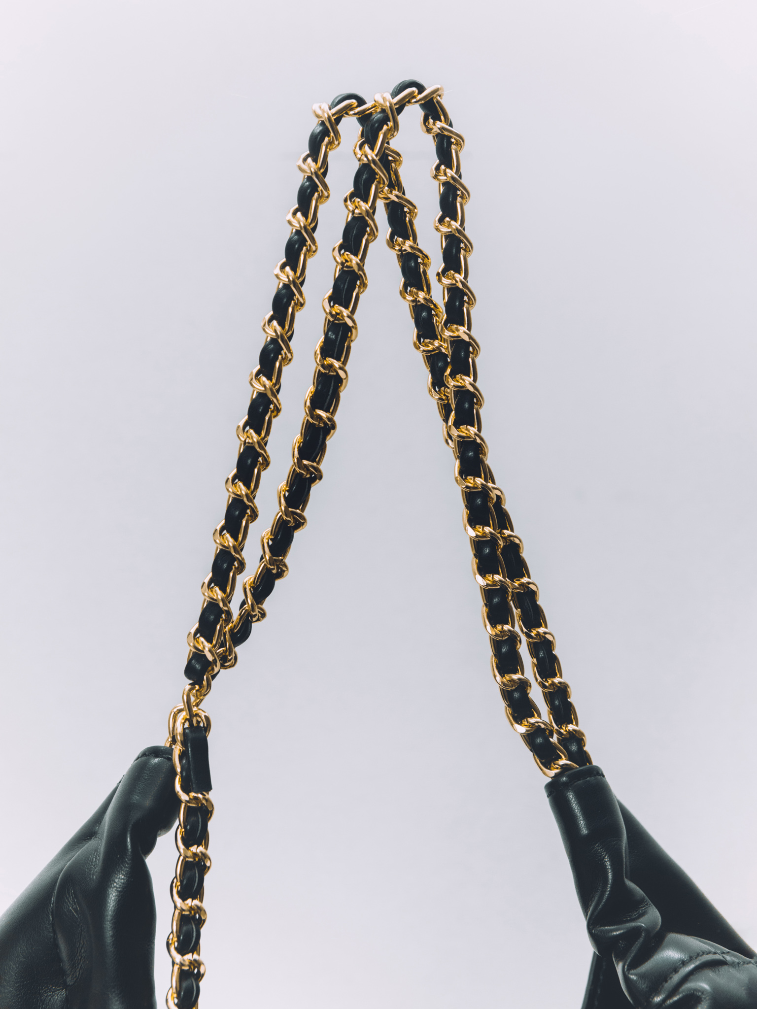 Soft-shaped bag with chain decor on the handles