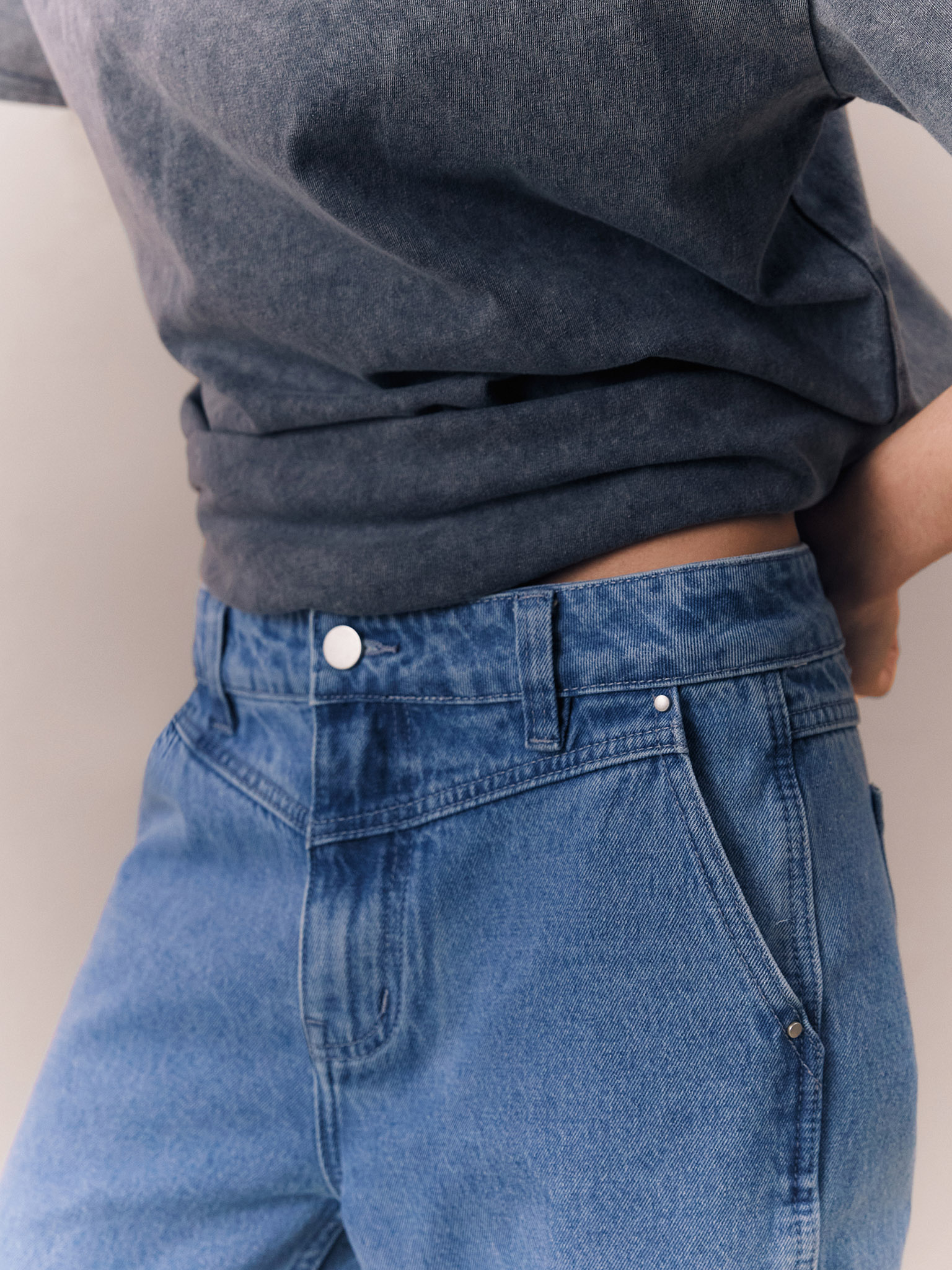 Flared jeans with triangle inset at waistband