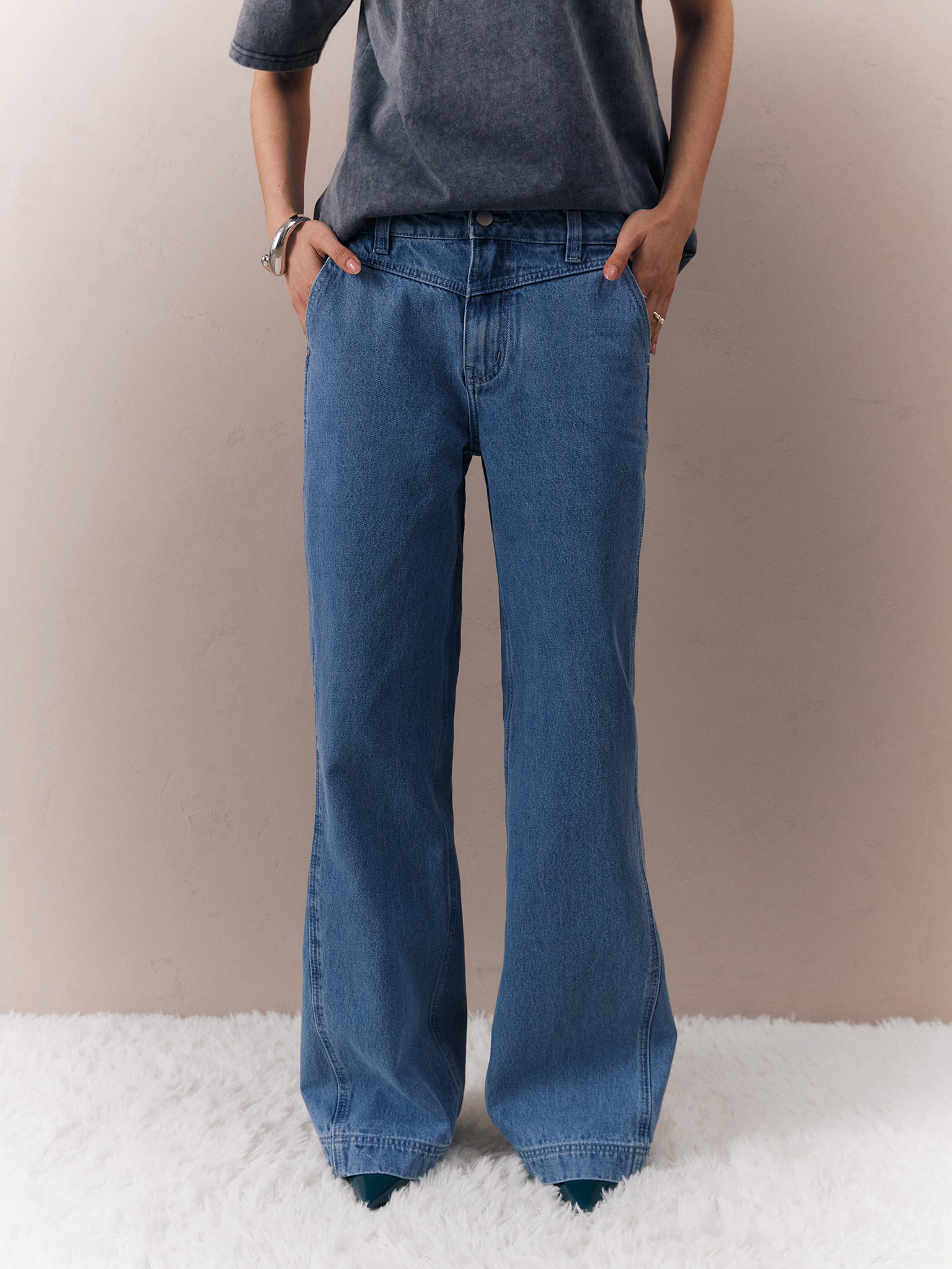 Flared jeans with triangle inset at waistband