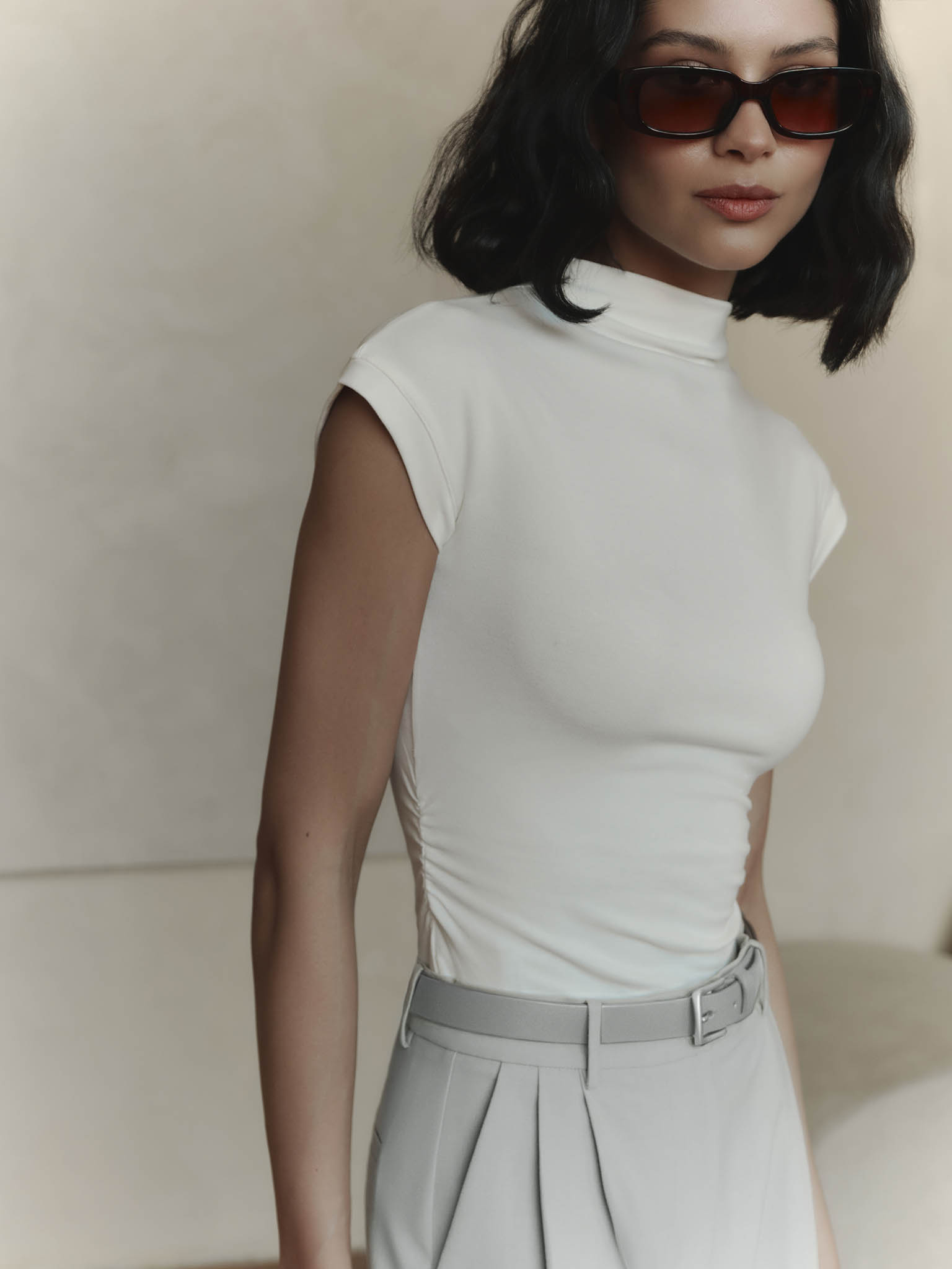 Sleeveless jersey top with stand-up collar