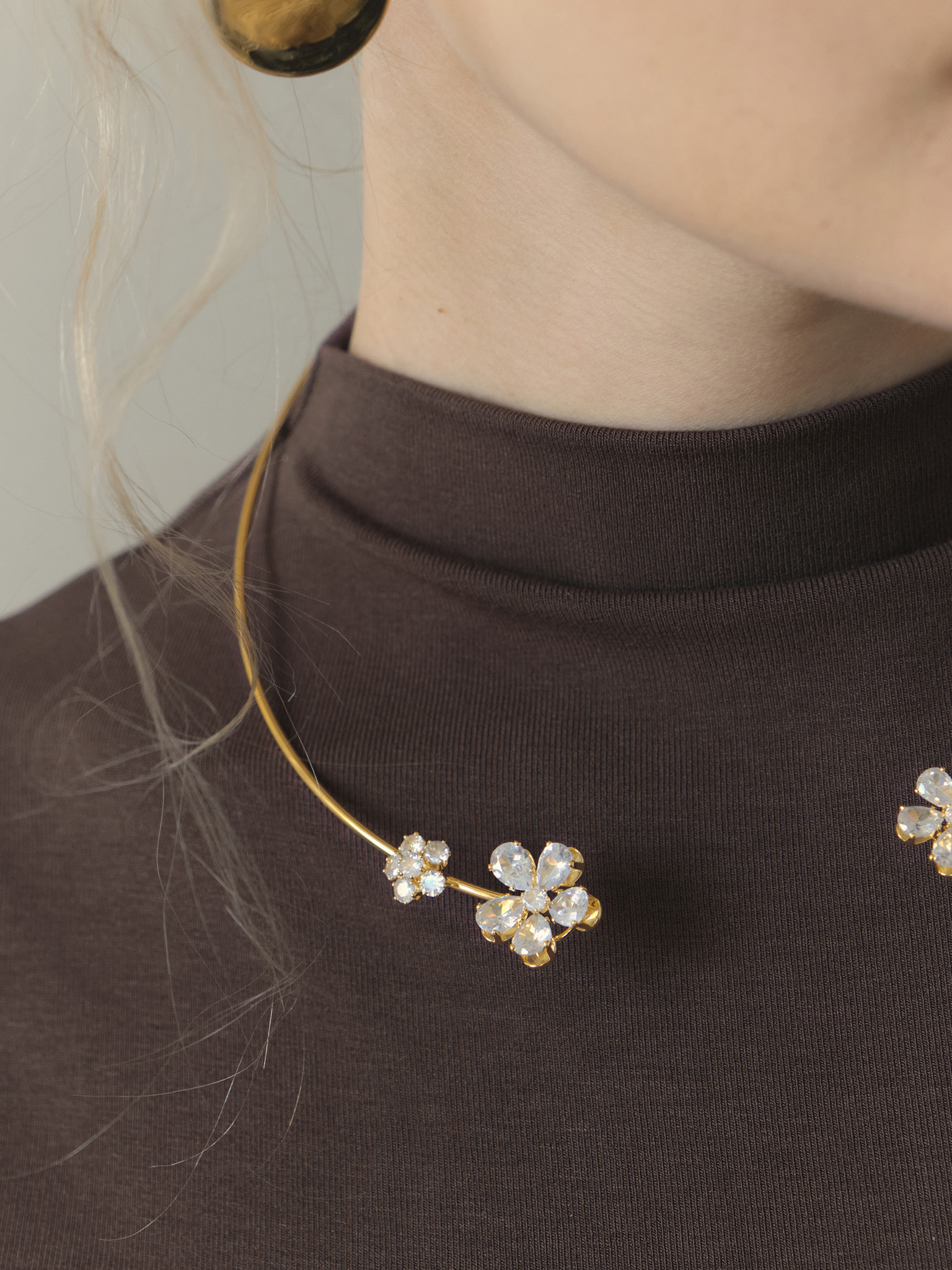 Slim golden necklace with stone flowers