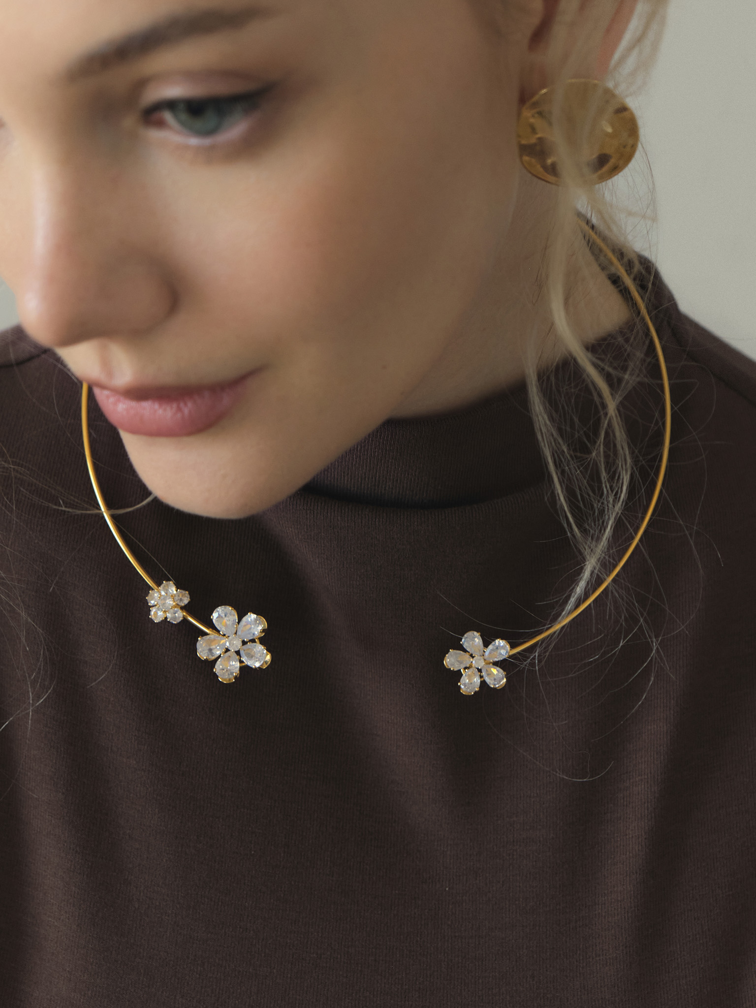 Slim golden necklace with stone flowers